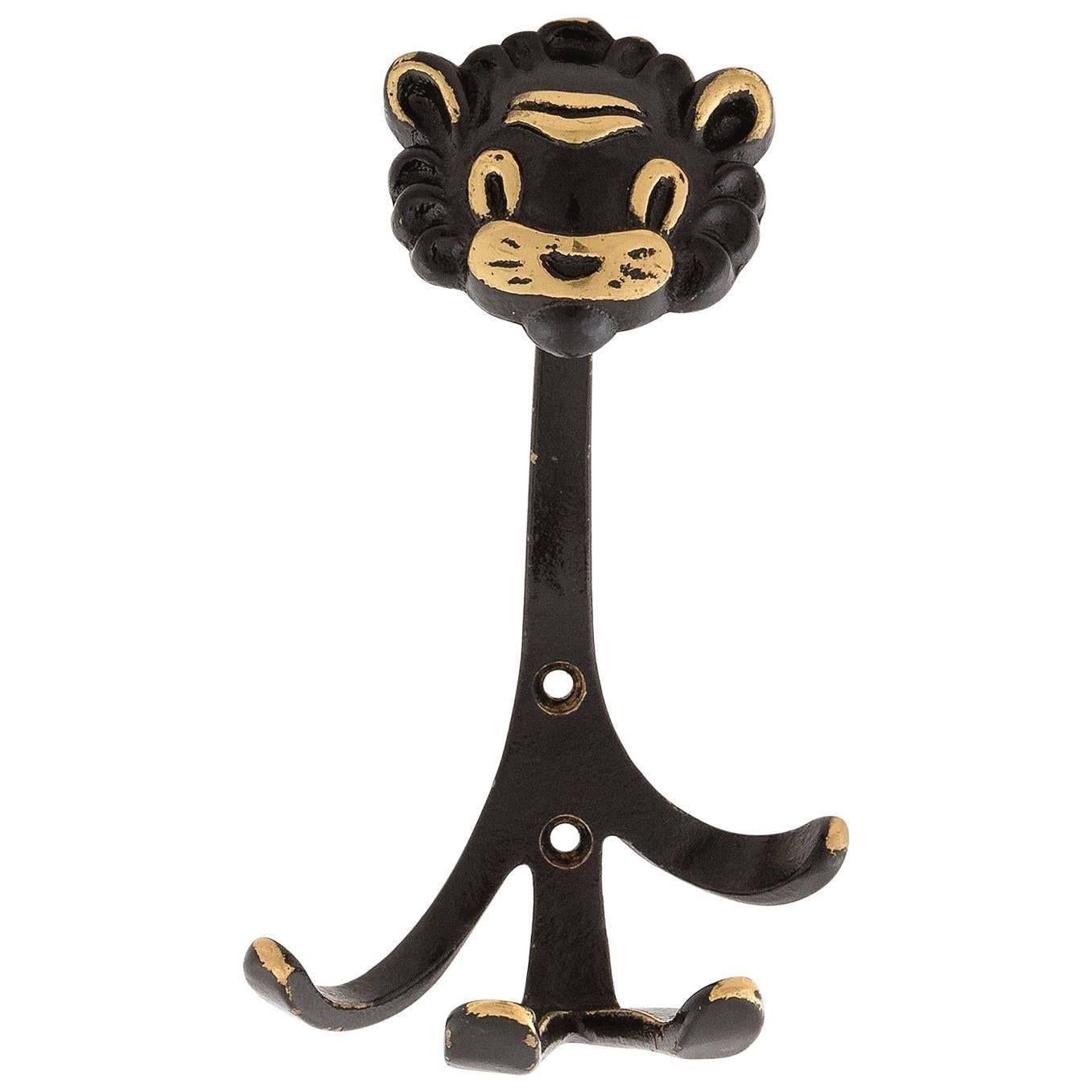 A set of six wall hooks in the form of three bulls, two monkeys, and one lion by Walter Bosse, Austria, manufactured in midcentury in 1950s. They are made of blackened and partly polished brass. 
Wear of use, lovely patina. 
The price is per hook.