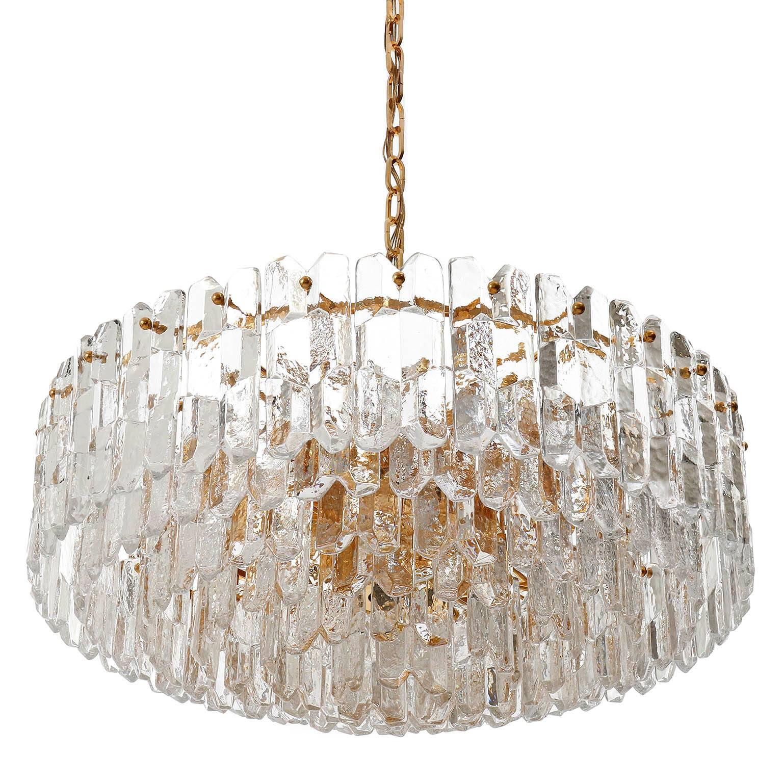 A large and very exquisite 24-carat gold-plated brass and clear brilliant glass 'Palazzo' chandeliers by J.T. Kalmar, Vienna, Austria, manufactured in circa 1970 (late 1960s and early 1970s).
Labeled and documented in the Kalmar catalogues from the