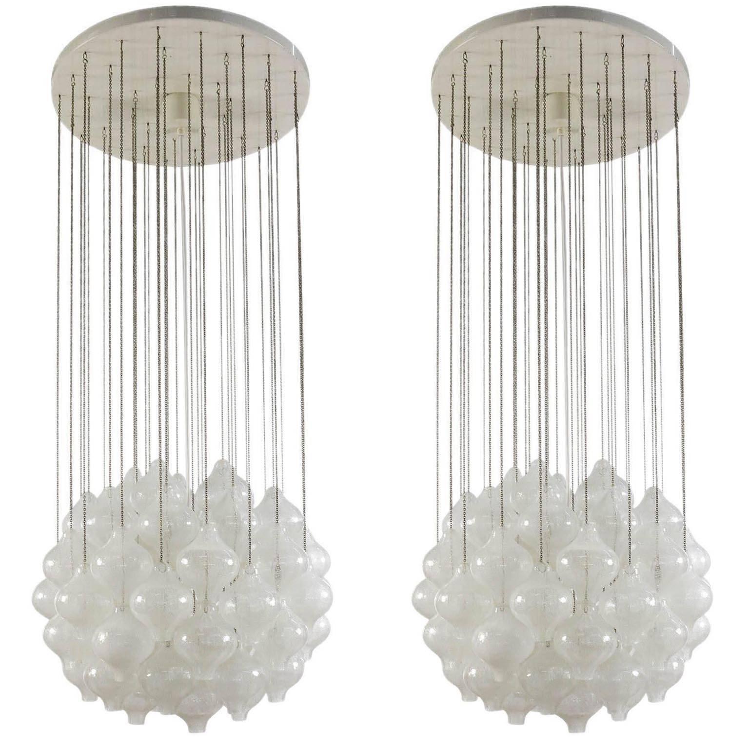 One of two glass pendant chandeliers model 'Tulipan' by J.T. Kalmar, Austria, Vienna, manufactured in Mid-Century, circa 1970 (late 1960s or early 1970s). The name Tulipan derives from the tulip shaped hand-blown bubble glass pieces. Each glass is