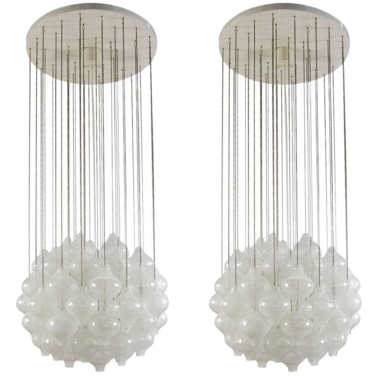 One of two glass pendant chandeliers model 'Tulipan' by J.T. Kalmar, Austria, Vienna, manufactured in Mid-Century, circa 1970 (late 1960s or early 1970s). The name Tulipan derives from the tulip shaped hand blown bubble glasses. Each glass is