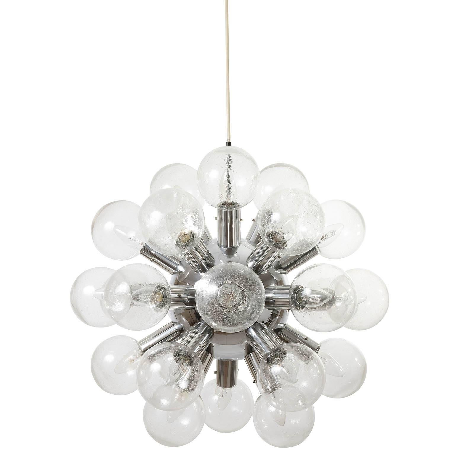One of four large 27-arm atomic chandeliers or pendant lights model 'RS 27 Kugel HL' by J.T. Kalmar, Austria, manufactured in midcentury, circa 1970 (late 1960s or early 1970s). 
They are made of polished aluminum and 27 hand blown bubble clear