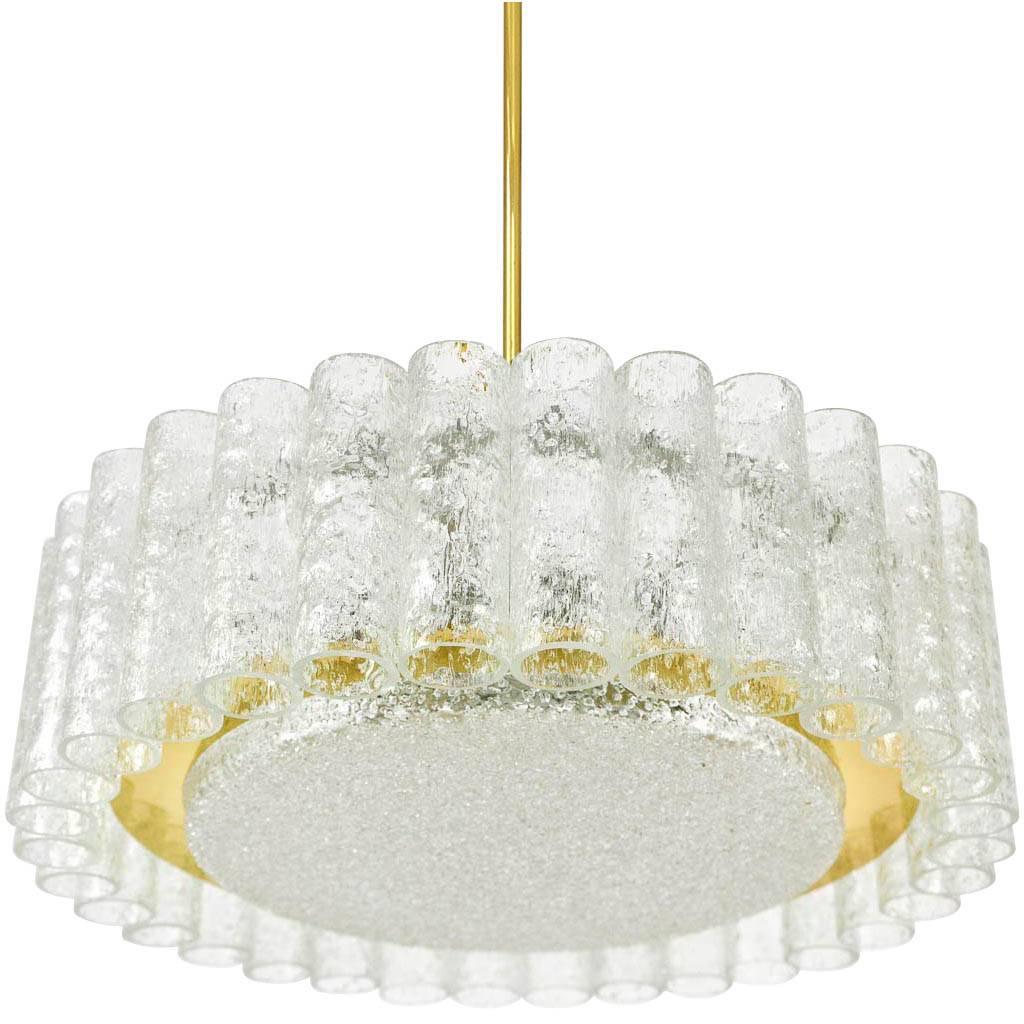 Very nice brutalist style pair of light fixtures by Doria, Germany, manufactured in Mid-Century, ca. 1970 (end of 1960s and beginning of 1970s). They are made of textured glass tubes / cylinders with a centered glass disc surrounded by a band of