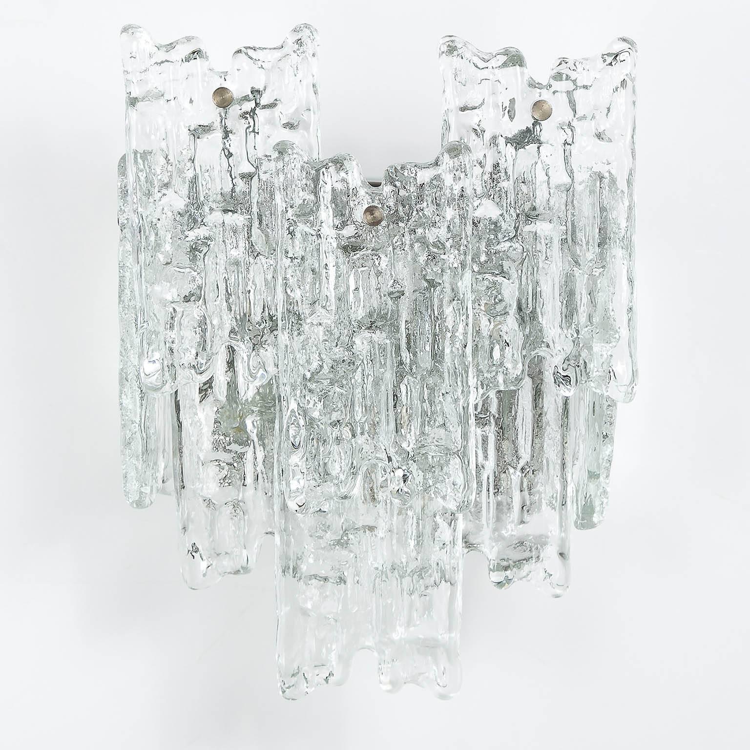 A beautiful pair of icicle glass sconces with 'Finger' glasses by Kalmar, Austria, manufactured in Mid-Century the 1960s. Each sconce is made of eight frosted glass blocks which are hanging on a nickel-plated hardware. Two E14 candelabra bulbs per