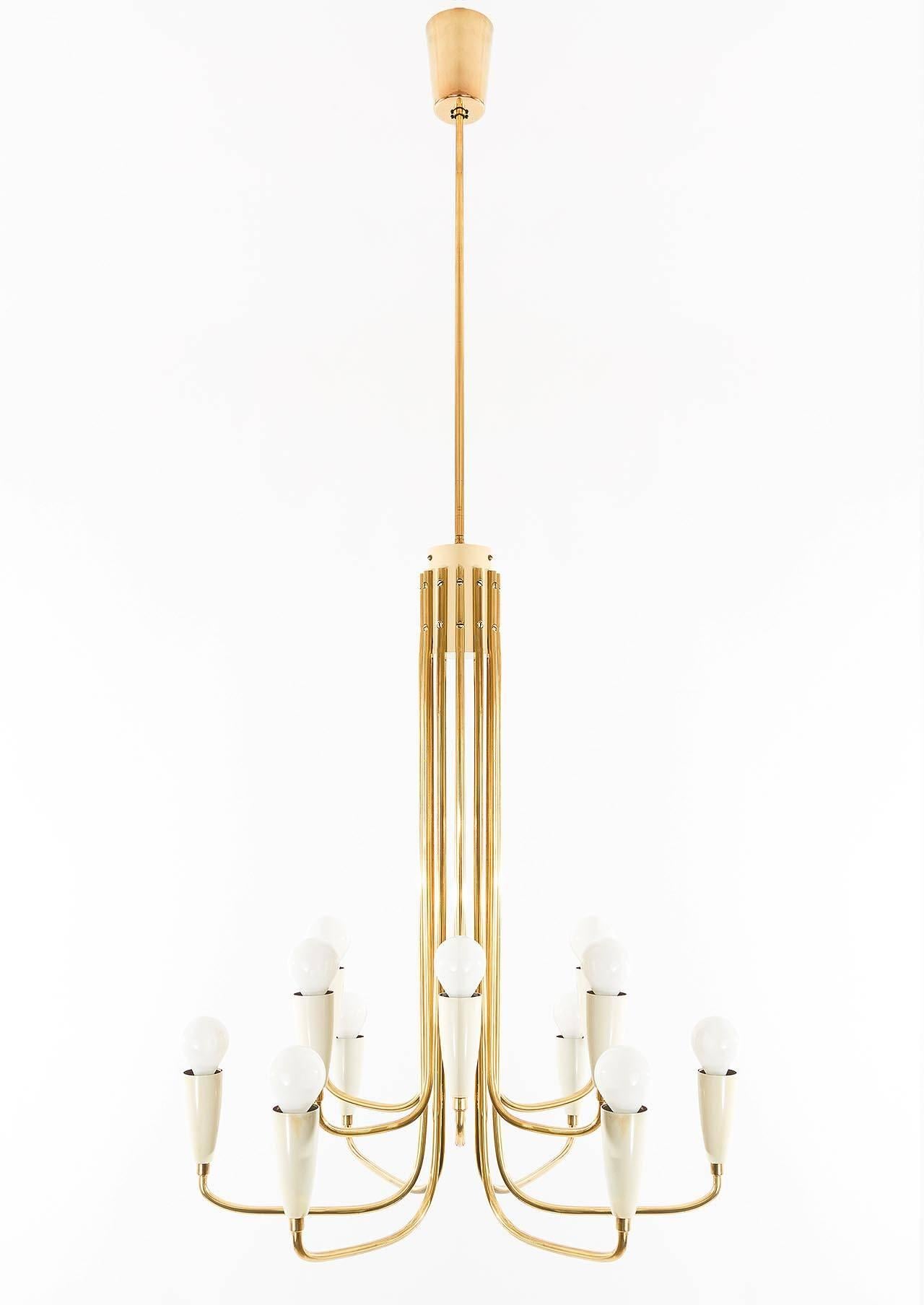 A beautiful 12-arm brass chandelier attributed to Rupert Nikoll, Austria, 1950's. 
The light has 12 sockets for small Edison screw base E14 bulbs or LEDs (max. 40W per bulb) which are covered with high-quality pressed glass lamp shades. It is