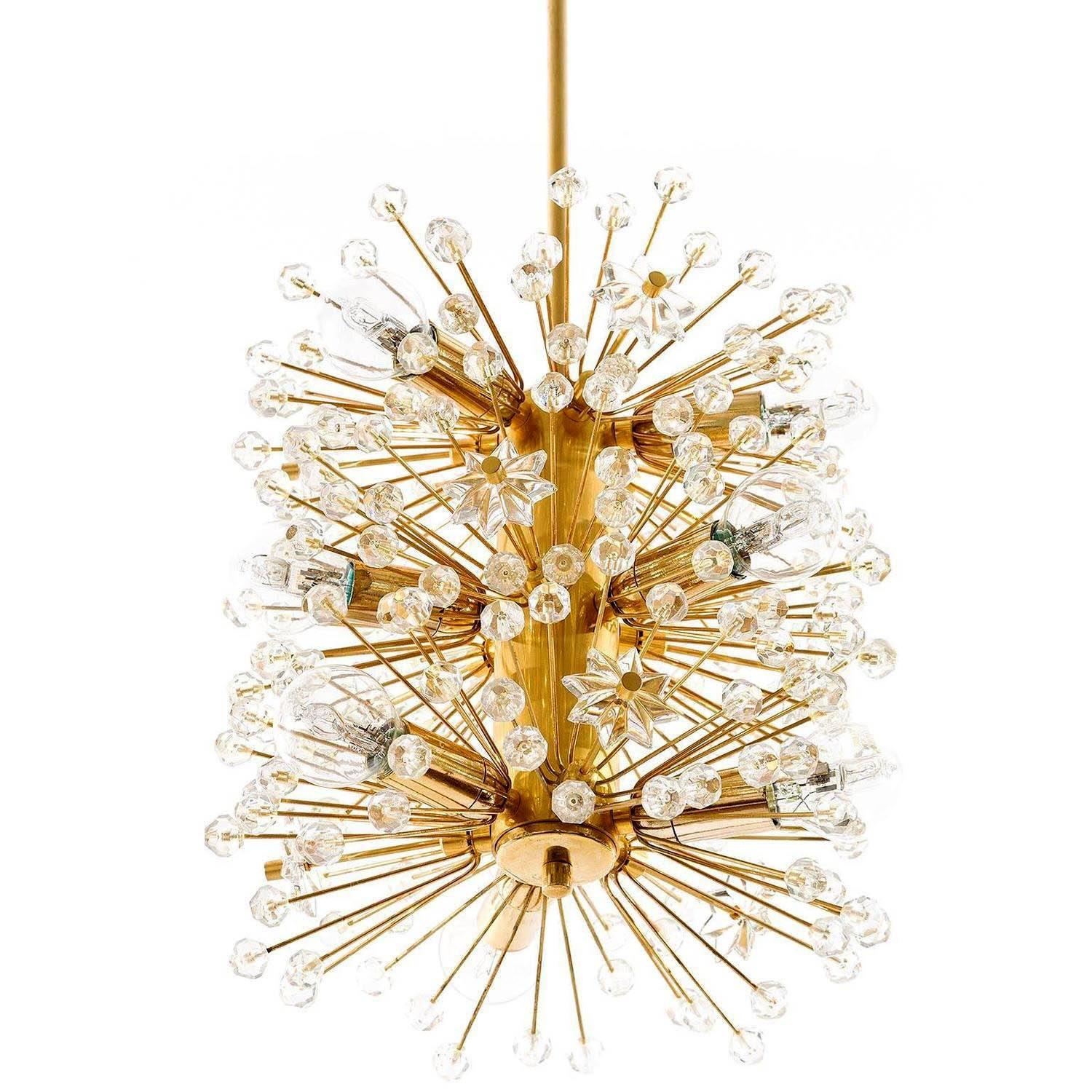 A beautiful gold-plated Viennese snowflake / blowball / Sputnik chandelier or pendant light, designed by Emil Stejnar for Rupert Nikoll and manufactured in Mid-Century in 1960s. This hollywood regency lamp is a high-quality piece, made of 24-carat