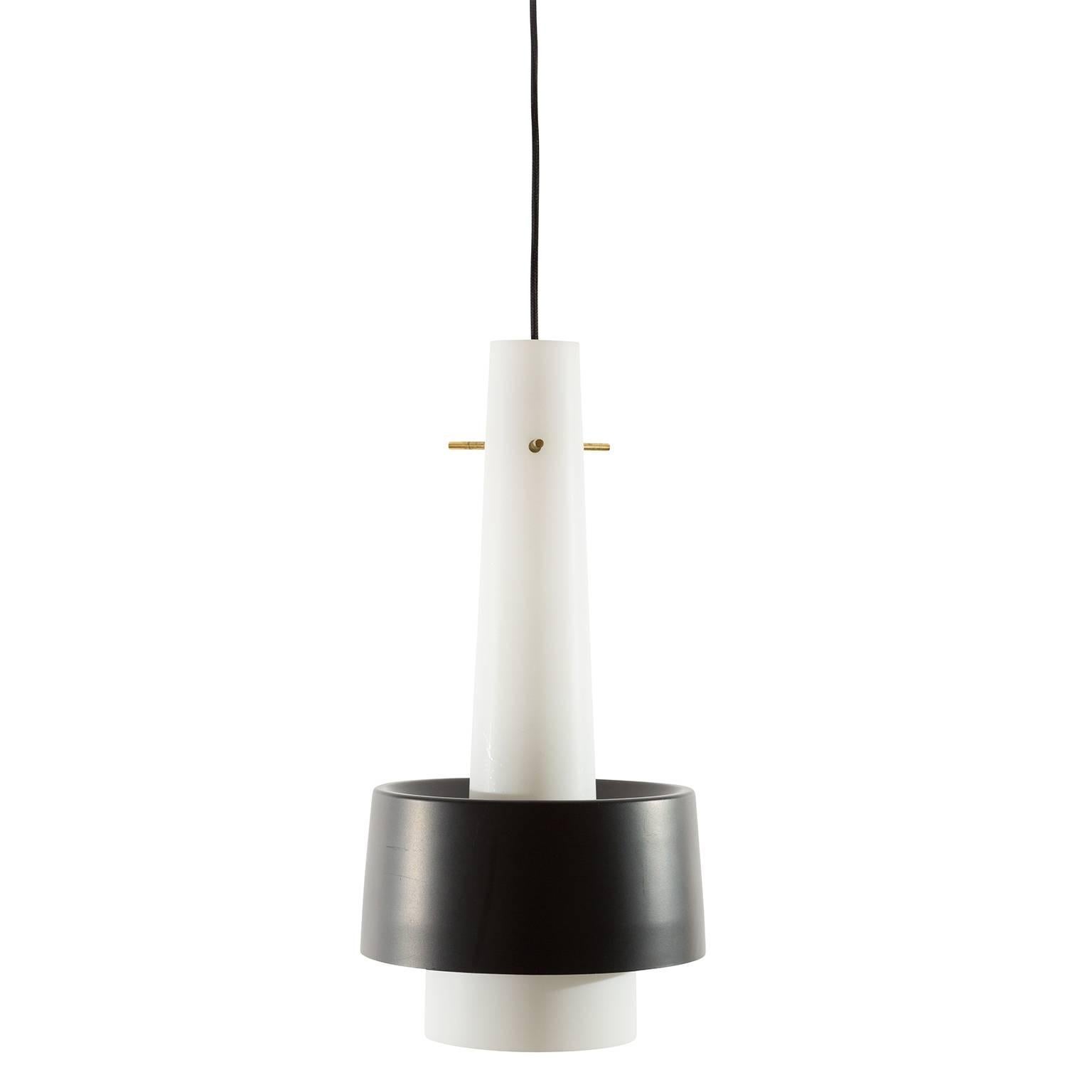 A set of three rare pendant light fixtures model 'Barett' by J.T. Kalmar, Austria, manufactured in midcentury, circa 1960. They are made of white satin opal glass and black lacquered metal shades.
Each lamp has one socket for a standard screw base