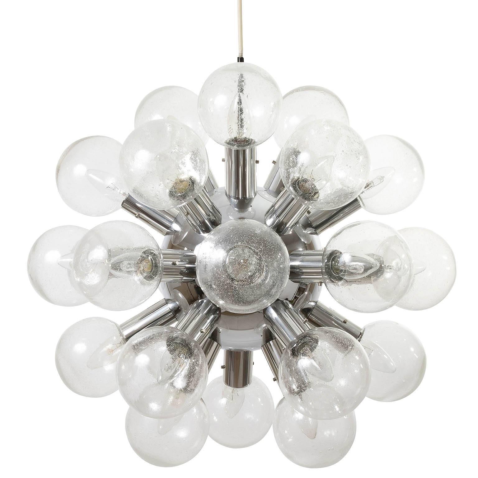 One of five rare and large 27-arm atomic chandeliers or pendant lights model 'RS 27 Kugel HL' by J.T. Kalmar, Austria, manufactured in Mid-Century, circa 1970 (late 1960s or early 1970s). 
They are made of polished aluminum and 27 handblown bubble