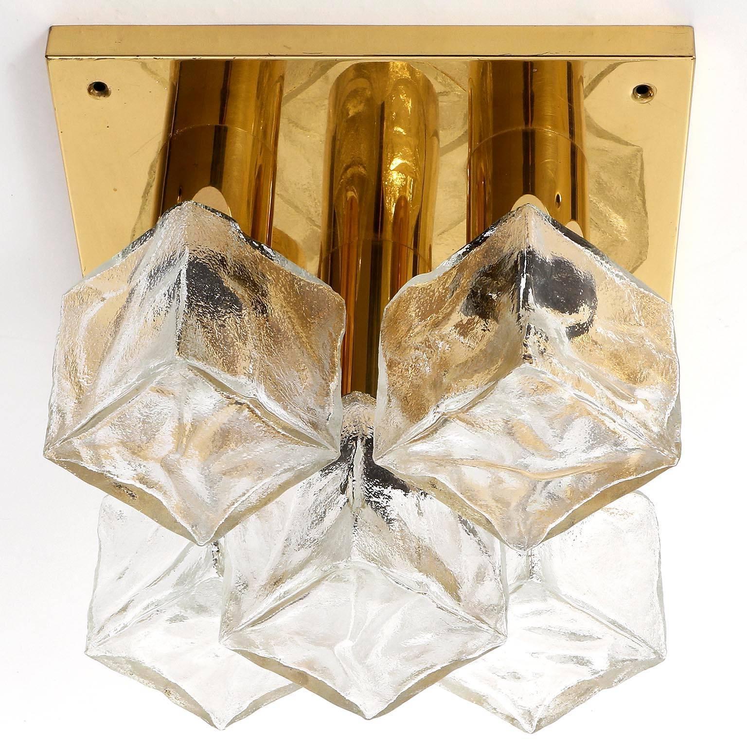 One of two modulare and square light fixtures model 'Cubus' (German 'Würfel') by J.T. Kalmar, Austria, manufactured in midcentury, circa 1970 (end of 1960s and beginning of 1970s).
They are made of polished brass and frosted cubic glass lamp shades.