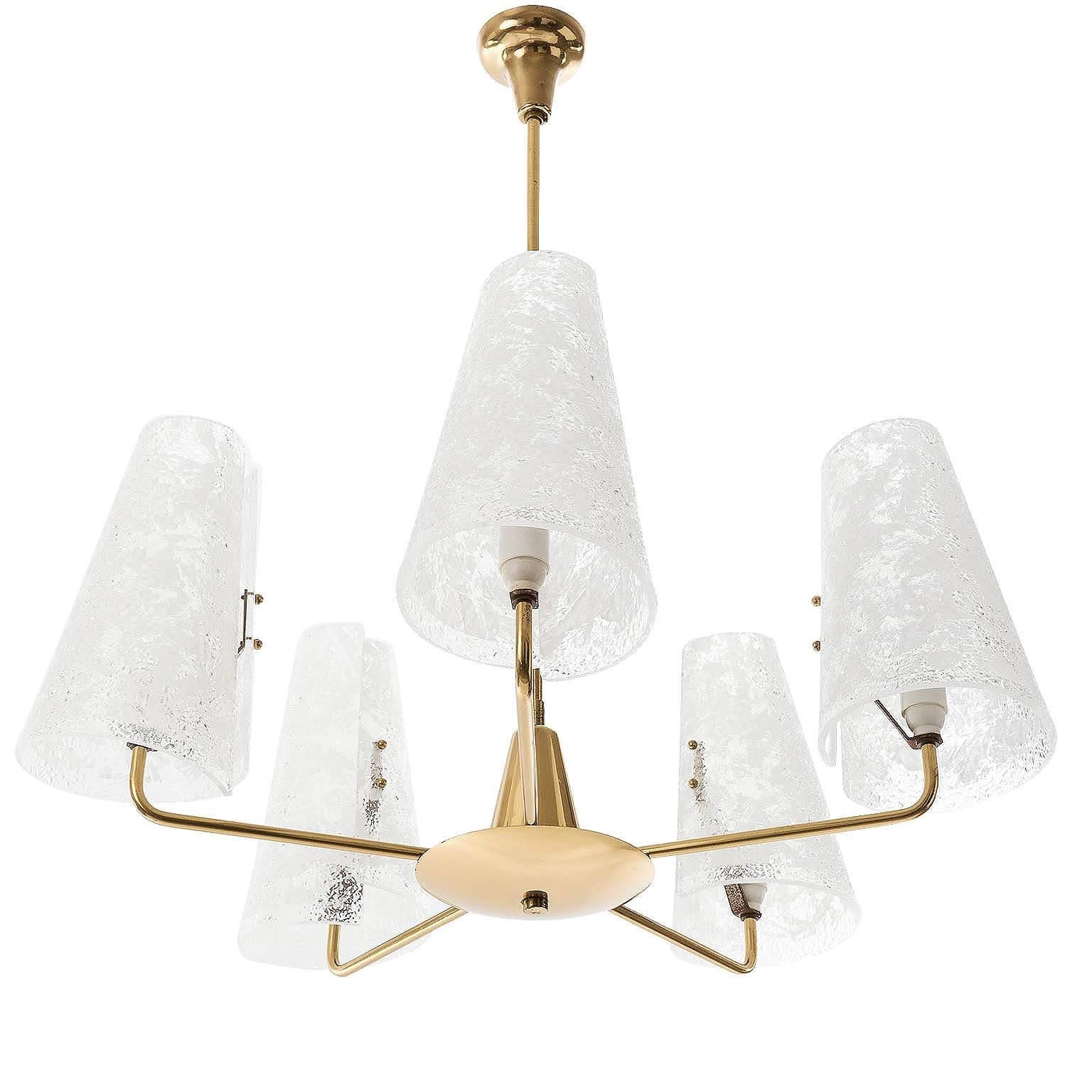 An Austrian solid brass and Lucite chandelier, manufactured in Mid-Century, circa 1950. 
The fixture has five arms with sockets for small screw base bulbs (E14 candelabra).
Light bulbs are not included. It is possible to install this fixture in all