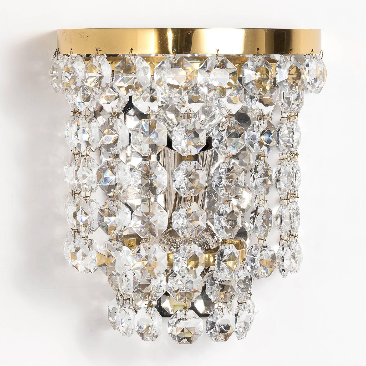 A pair of handmade and high quality sconces by Bakalowits & Sohne, Vienna, 1950s-1960s. They are made of a nickel-plated backplate which holds two brass rings decorated with diamond shaped handcut crystals.
Each fixture takes one small screw base