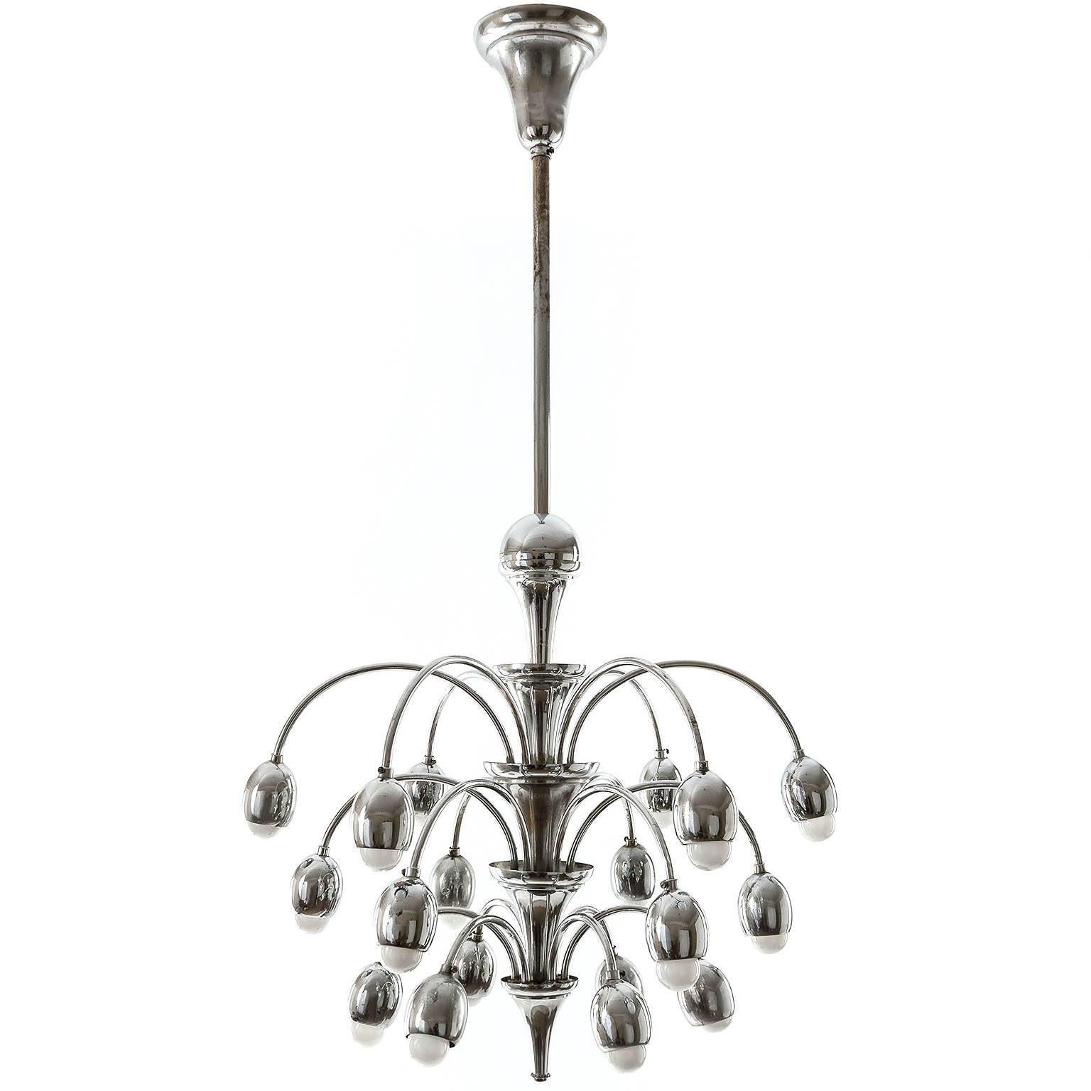 A large and stunning Art Deco chandelier, Austria, circa 1930. A nickel-plated brass frame with 18 arms and sockets for medium base screw bulbs (LED or filament).
The light is in very good condition. It has been professionally cleaned and rewired