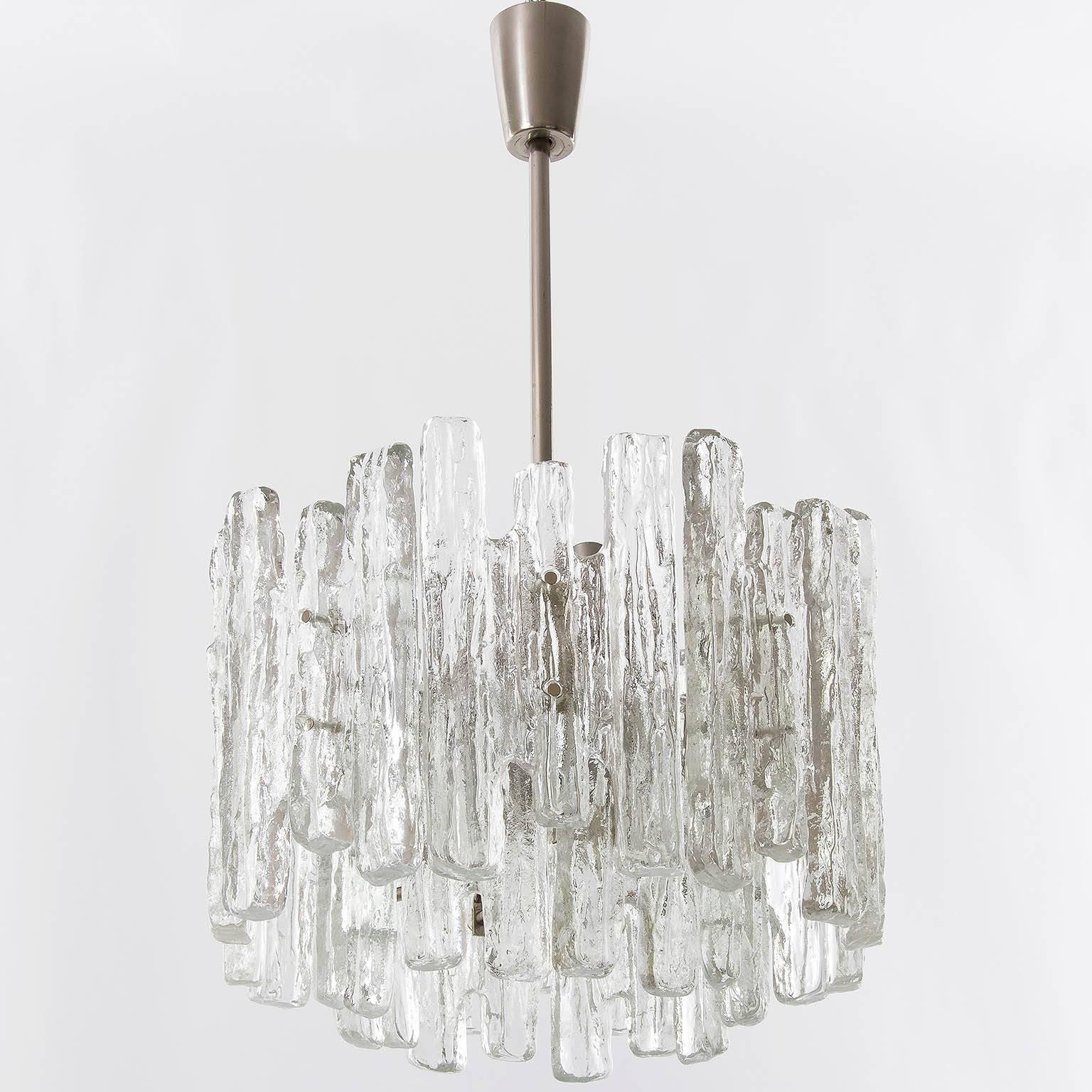 A beautiful ice glass chandelier, pendant, light by Kalmar, manufactured in Mid-Century, circa 1970 (late 1960s or early 1970s). 
This is the rarer version of the icicle glass fixtures from Kalmar with larger unusual glasses and a chrome or nickel