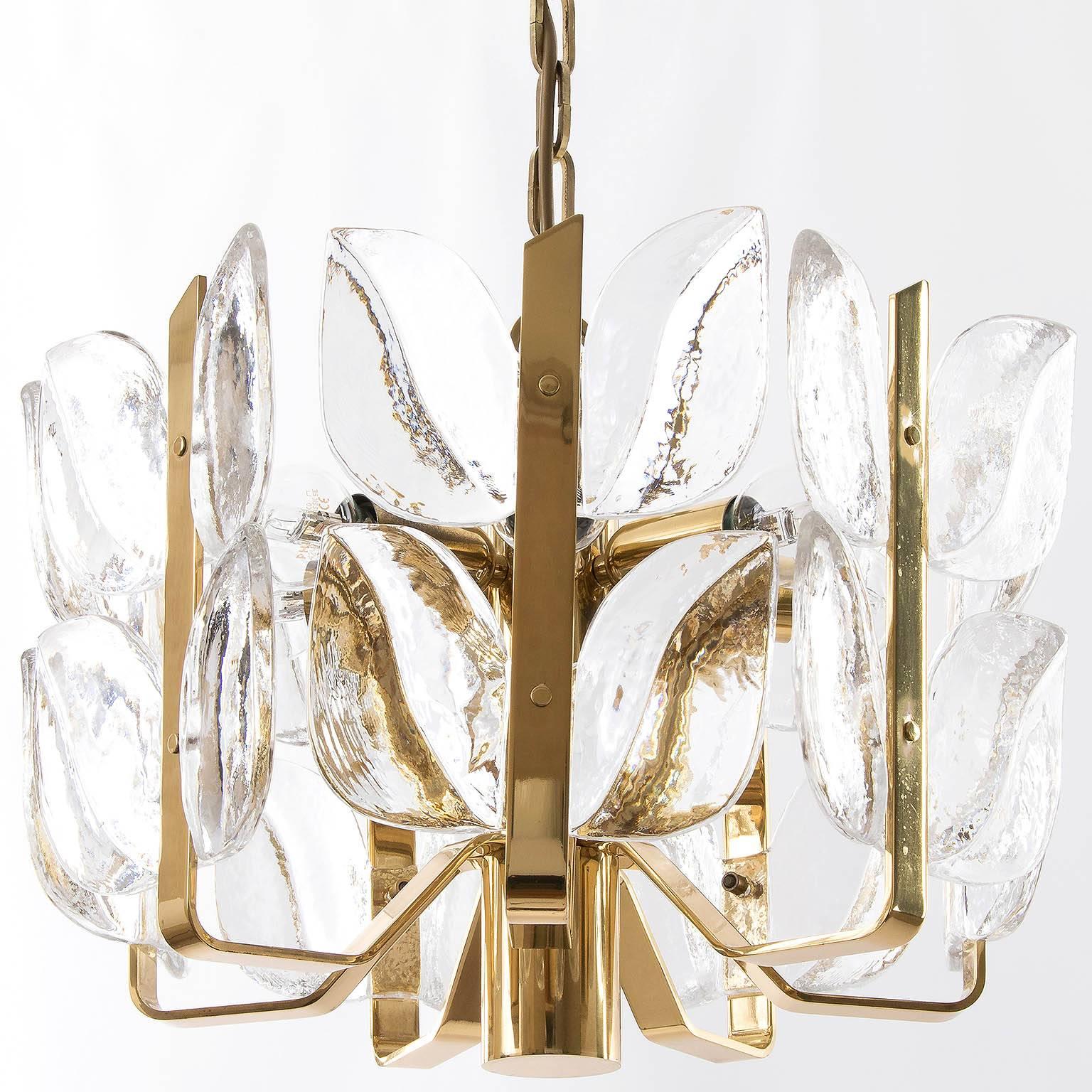 Handmade and high quality chandelier by J.T. Kalmar, Austria, 1960s. Made of polished brass and large fire-polished brillant crystal glasses.
Excellent original condition with very little patina on brass. Seven small base bulbs (max. 40 W per