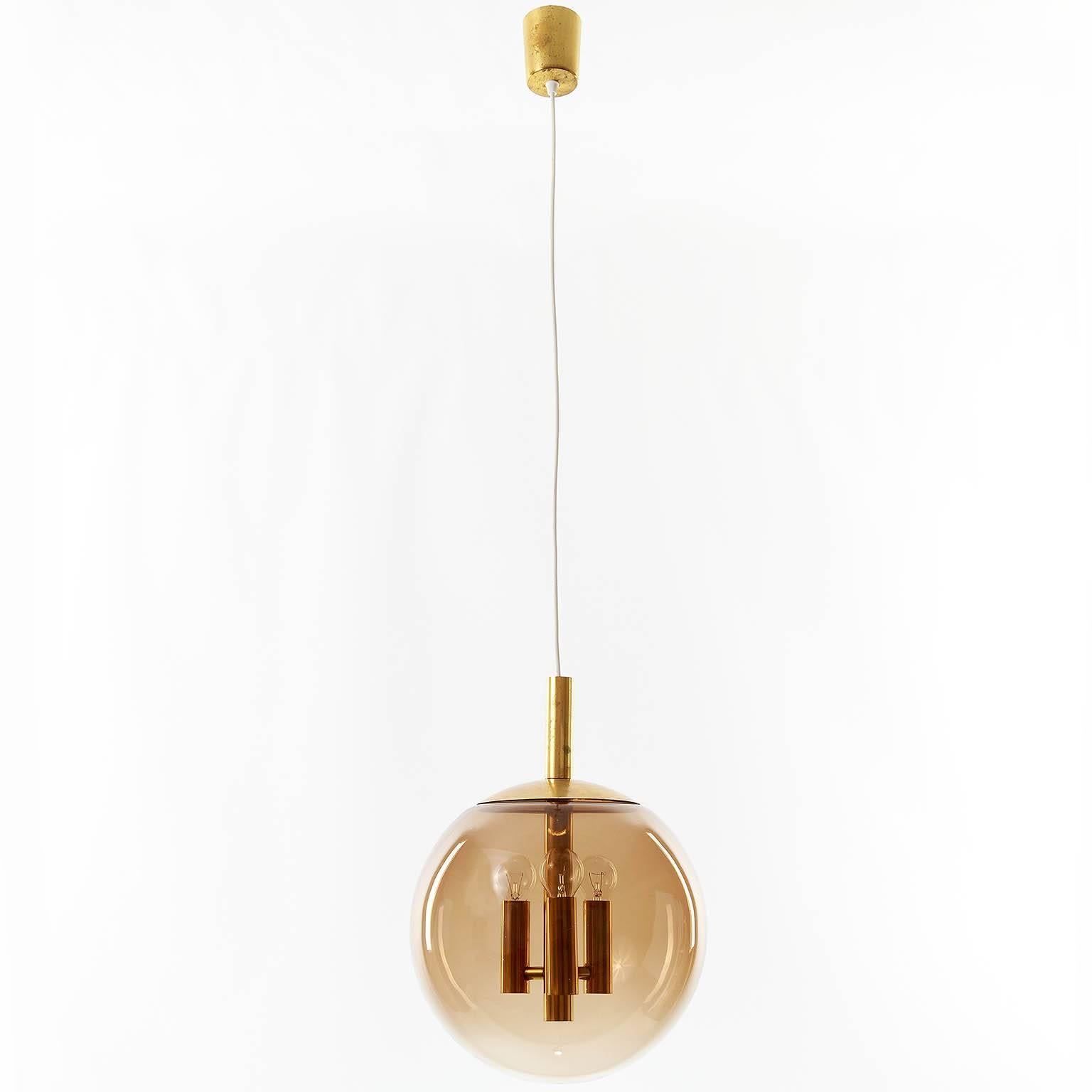 German Limburg Pendant Light Brass and Amber Tone Glass Globe, 1960s For Sale