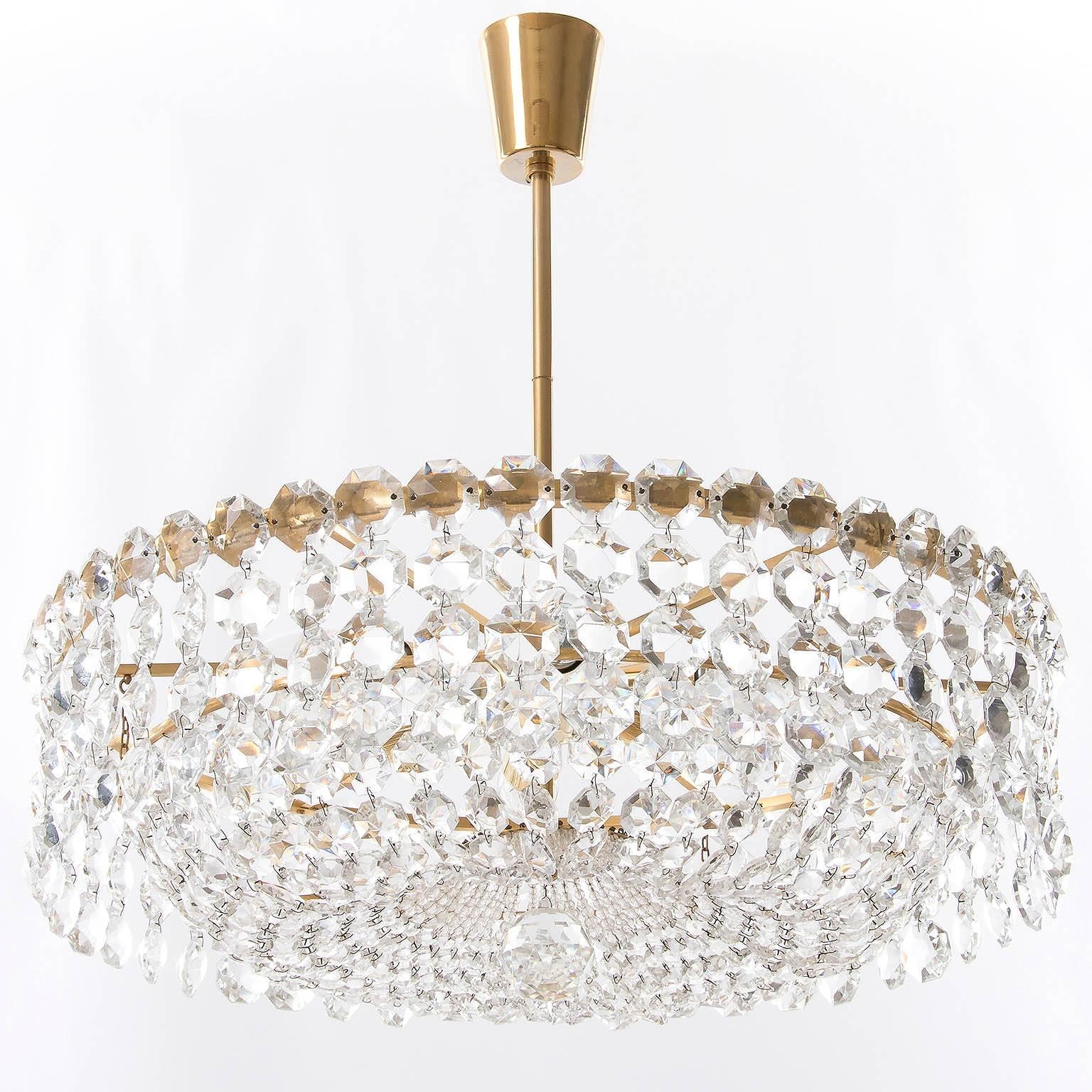 One of two very exclusive and high quality pendant chandeliers by Bakalowits & Söhne, Austria, manufactured in Mid-Century, circa 1960. 
Each chandelier is made of a gold-plated brass frame decorated with hundreds of faceted glass crystals. 
There