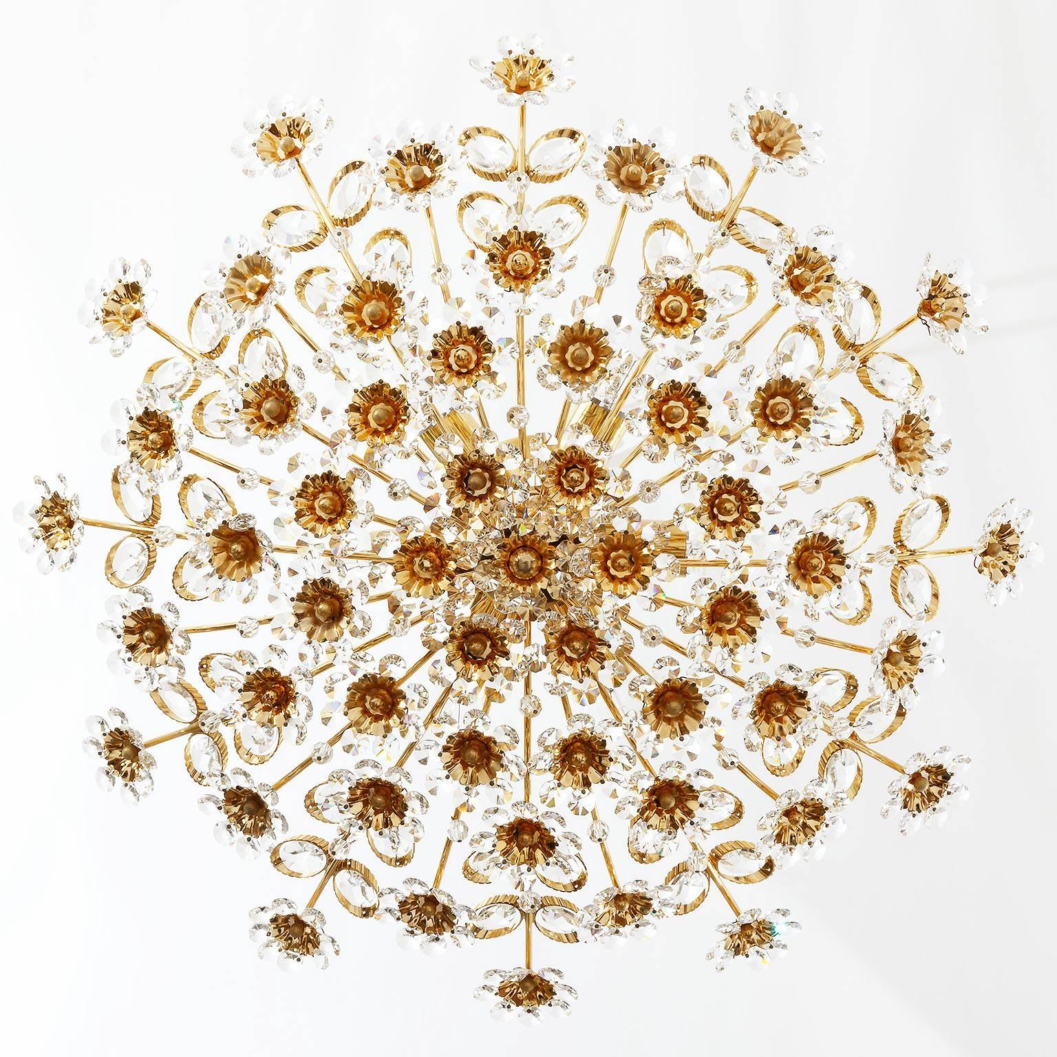 Wonderful floral ceiling light fixture by Palwa from the 1960s. High quality craftsmanship. A gilded brass frame holds many flowers made of diamond shaped crystal glasses. Six small base Edison bulbs. 
It can be used as flush mount lamp or