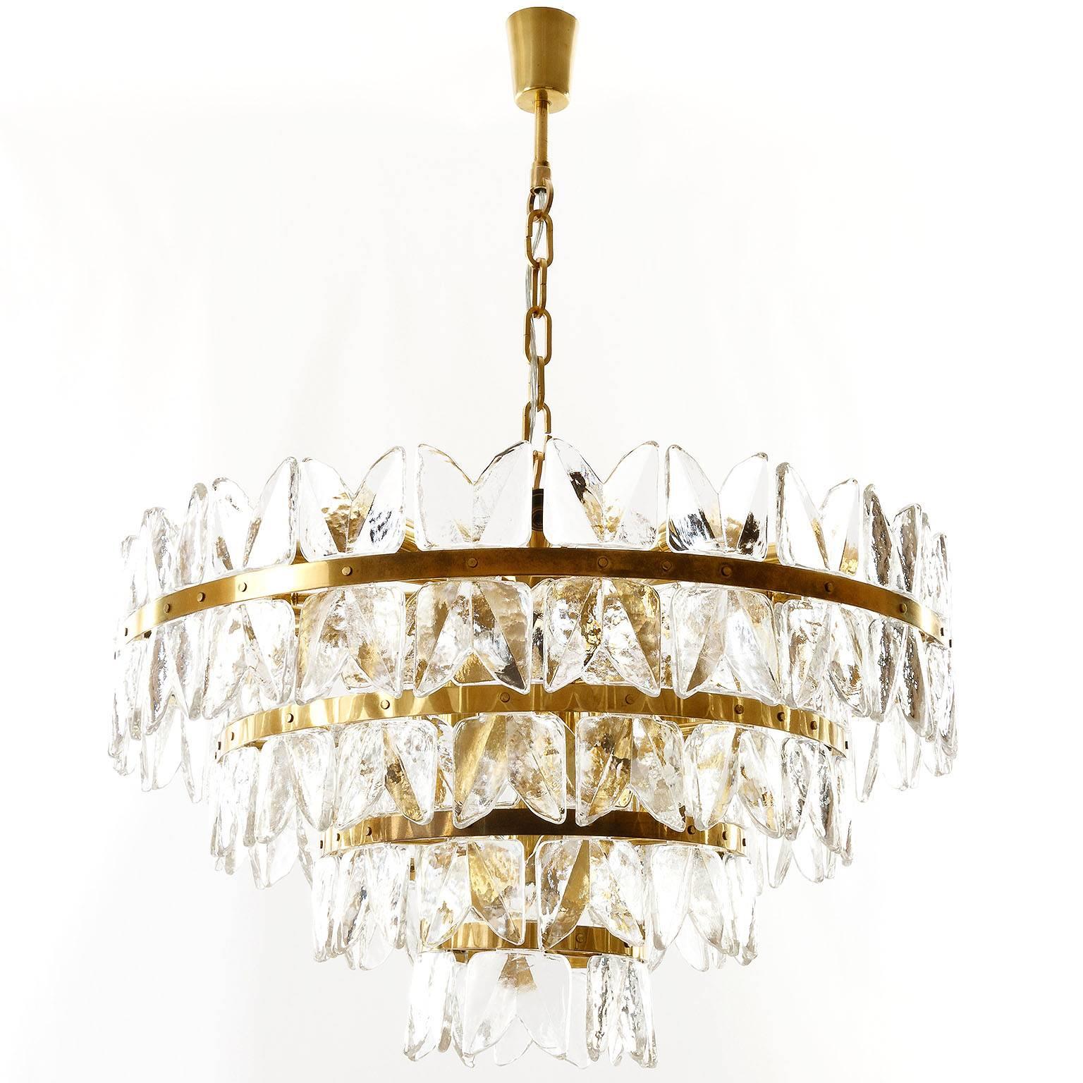 A very exclusive and large ice glass chandelier or pendant light model "Corina" by J.T. Kalmar, Vienna, Austria, manufactured in Mid-Century, circa 1970 (at the end of 1960s and beginning of 1970s). 
An impressive handmade and high quality