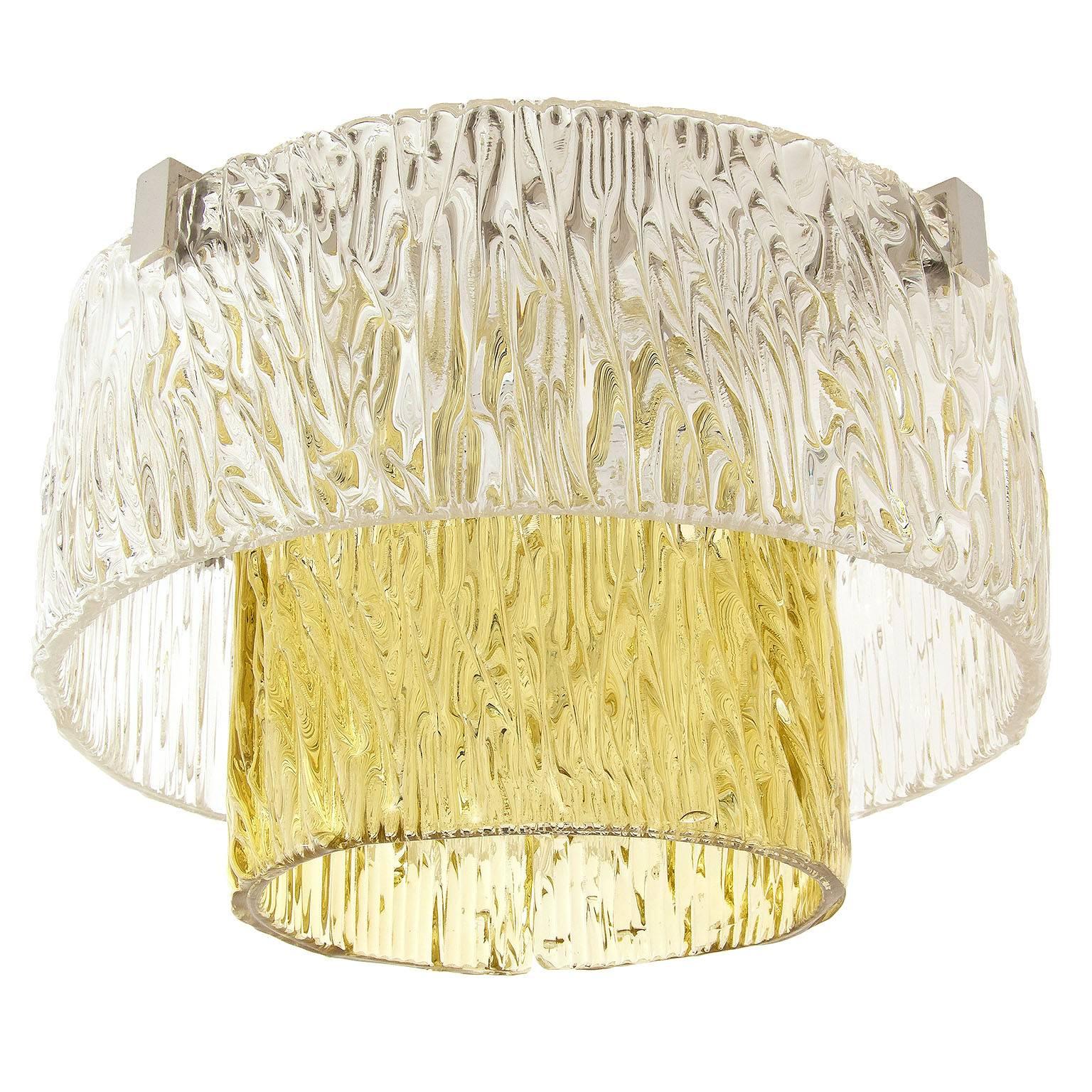 Only three pieces are available.

One of three fantastic textured glass and nickel-plated brass light fixtures by J.T. Kalmar, Austria, manufactured in Mid-Century, circa 1960. 
The outer tier is made of two clear glass half rings. The inner ring is