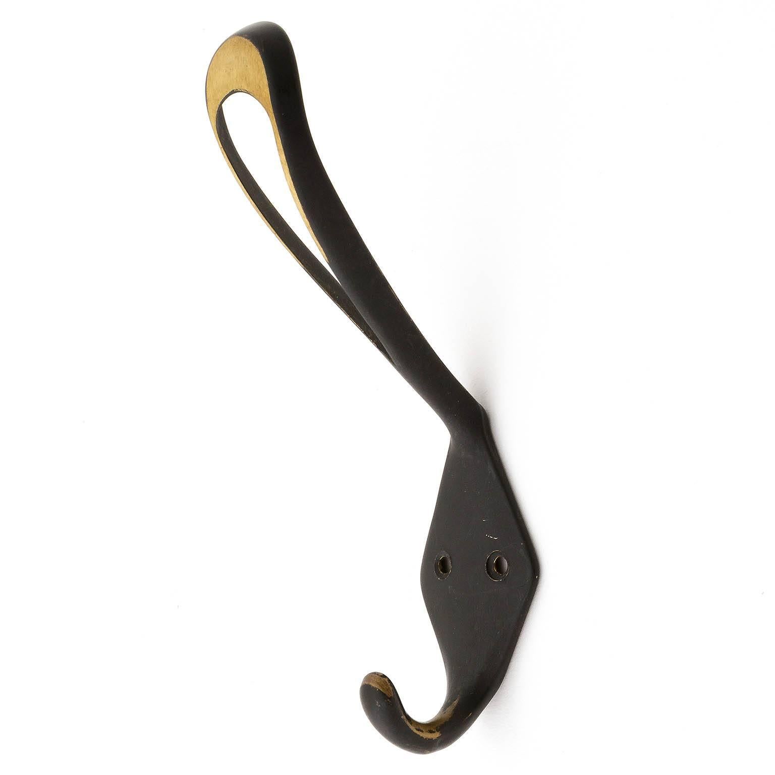 Seven beautiful Austrian brass hooks in the style of Hertha Baller or Carl Auböck, manufactured in the 1950s. They are made of blackened and partly polished solid brass. Lovely patina.
There are further brass coat hooks in different shapes and