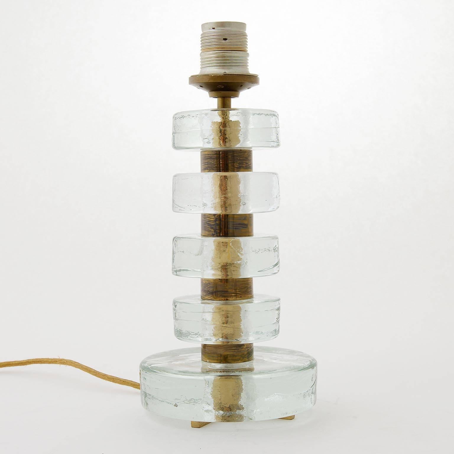 A high quality table light by Bakalowits & Söhne, Vienna, manufactured in Mid-Century, circa 1960. The stand is made of thick round pieces of frosted glass stacked with brass spaces. The stand is in original condition with patina on brass. The