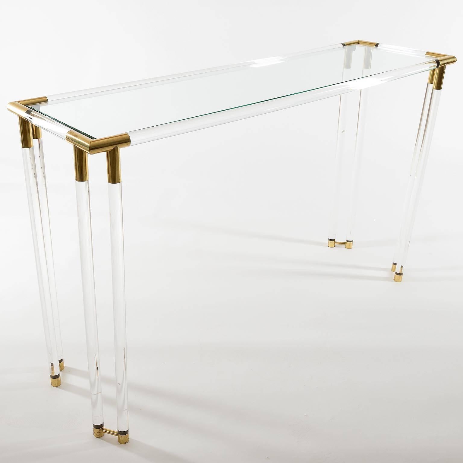 A large and stylish French, brass, glass and Lucite rectangular console table in the manner of Pierre Vandel, Paris, manufactured in Mid-Century in 1970s. 
Nice patina on brass.

To reduce shipping costs the table will be disassembled. The two long