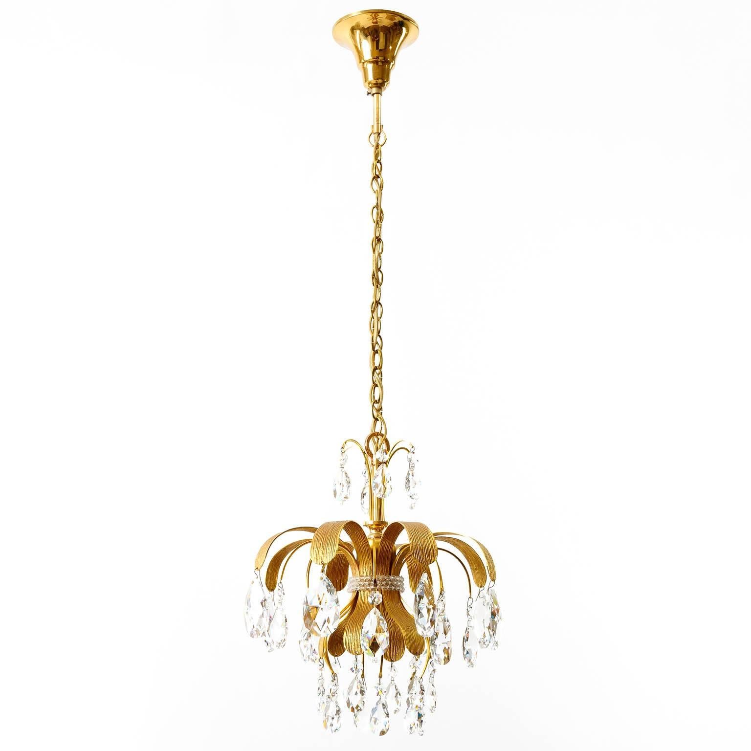 A set of three very exclusive 24-carat gold-plated pendant light fixtures by Palwa (Palme & Walter), Germany, manufactured in Mid-Century in late 1960s and beginning of 1970s. Handmade and high quality pieces. They are made of a gilded brass frame