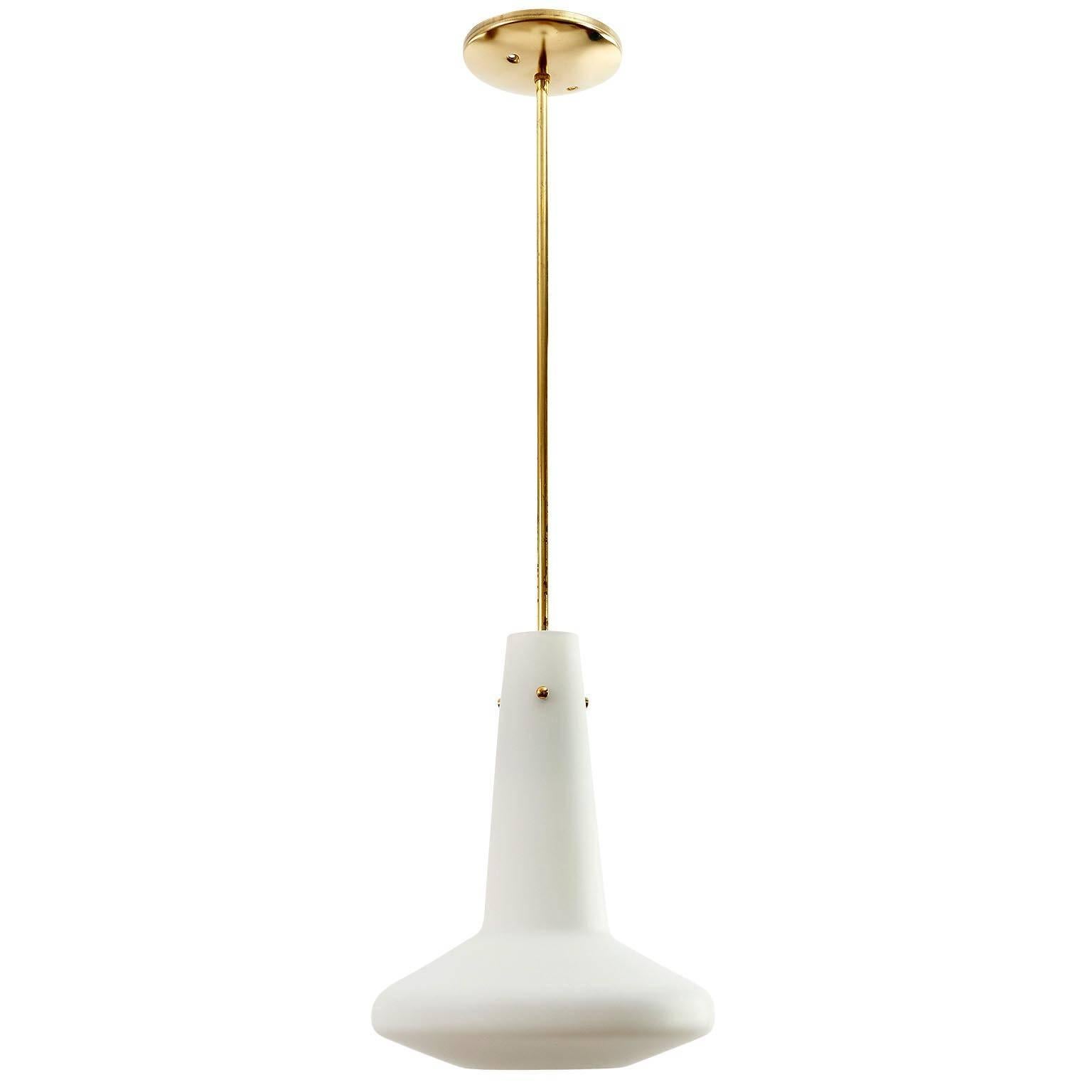 A pair (set of two) pendant light fixtures by Rupert Nikoll, Austria, manufactured in Mid-Century, circa 1960 (late 1950s or early 1960s). The lights are in the style of Italian maker Stilnovo.
A white opaline glass body is mounted on a brass stem