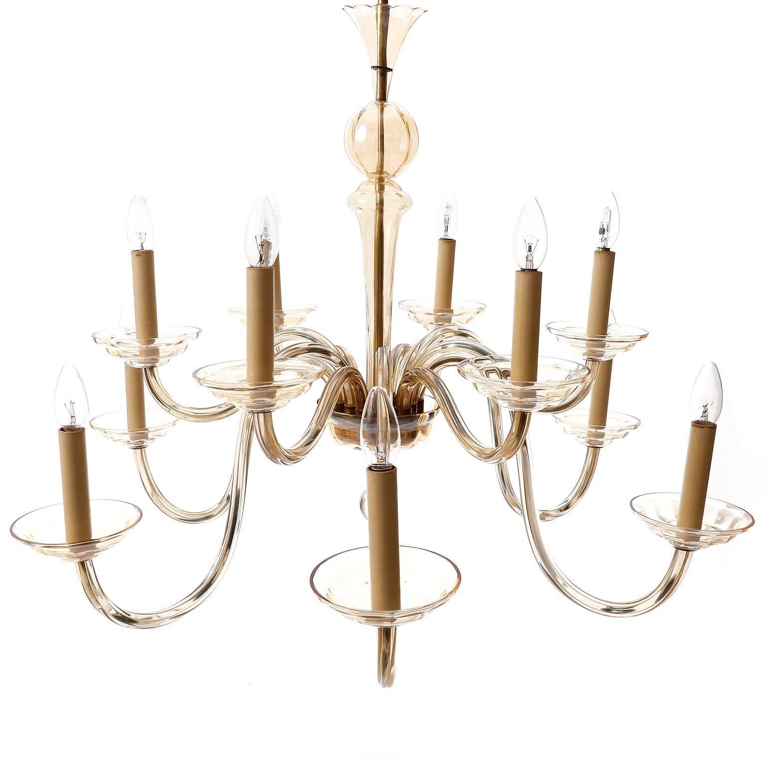 A beautiful and large Art Deco light fixture by J.L. Lobmeyr, Vienna, Austria, 1930s. This chandelier has twelve arms with sockets for candelabra E14 screws base bulbs (LED or filament). It is made of brass with lovely natural aged patina and
