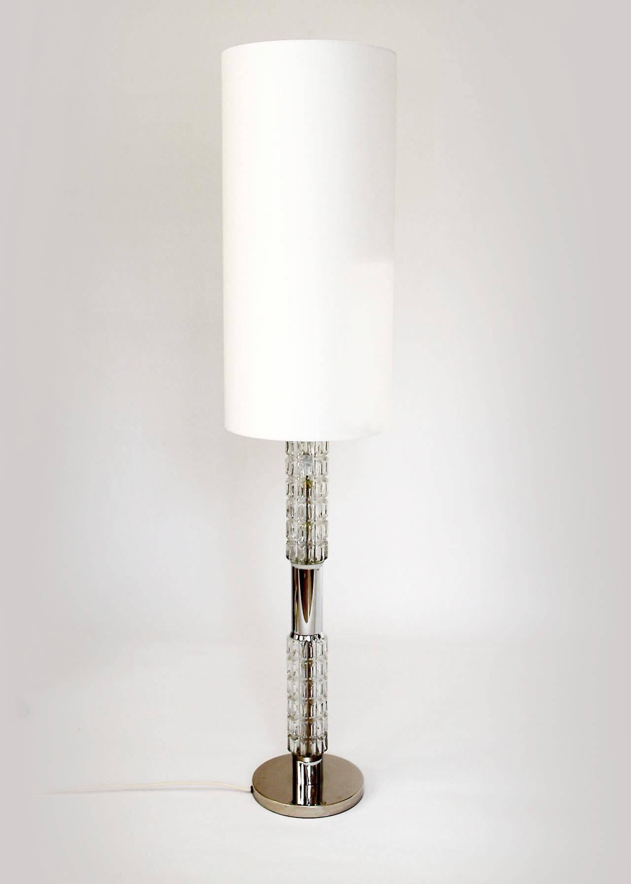 A stunning chrome and structured glass floor or table lamp by Richard Essig, Besigheim, Germany, manufactured in Mid-Century, circa 1970. 

This light has a very nice feature:
There are three bulbs which can be switched on in three different ways