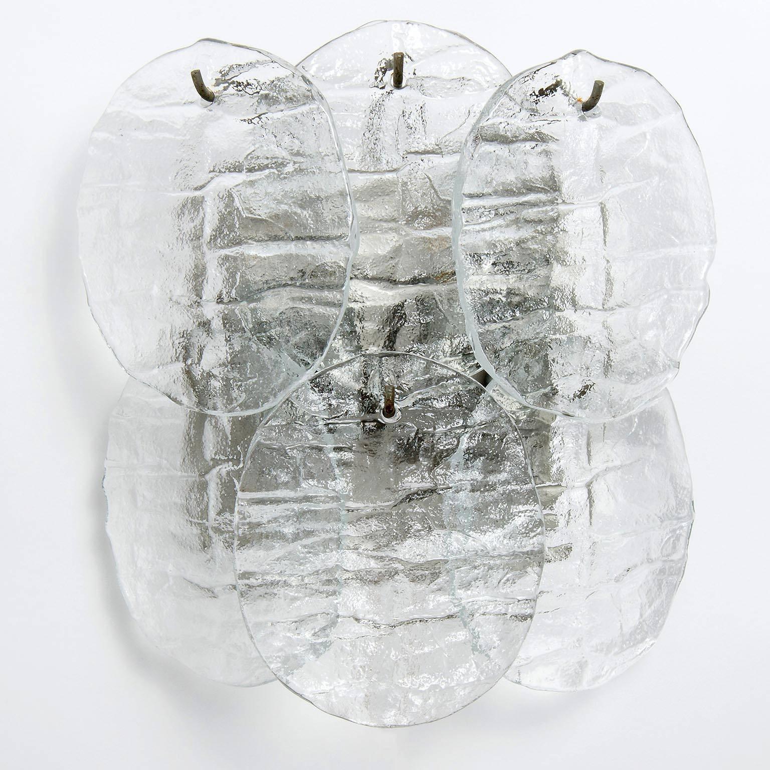 A set of two large light wall lights model 'Blatt' (Blatt is the German word for leaf) by Kalmar, Austria, manufactured in Mid-Century, circa 1970 (late 1960s or early 1970s).
Six disc shaped clear glasses in the form of leaves hang with nickel