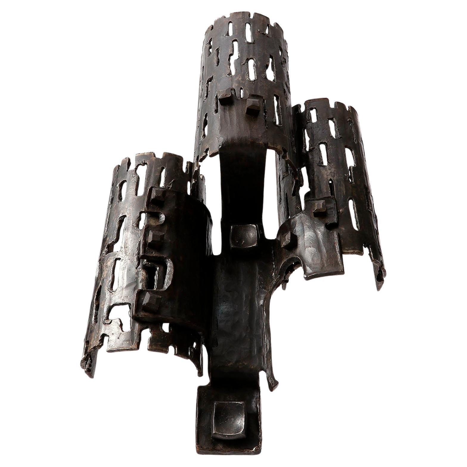 A pair of one-of-a-kind Brutalist style wall lamps made of metal with great patina, manufactured in Germany in Mid-Century, circa 1970 (end of 1960s or early 1970s). 
Custom made pieces made of blackened iron.
A massive and very impressive