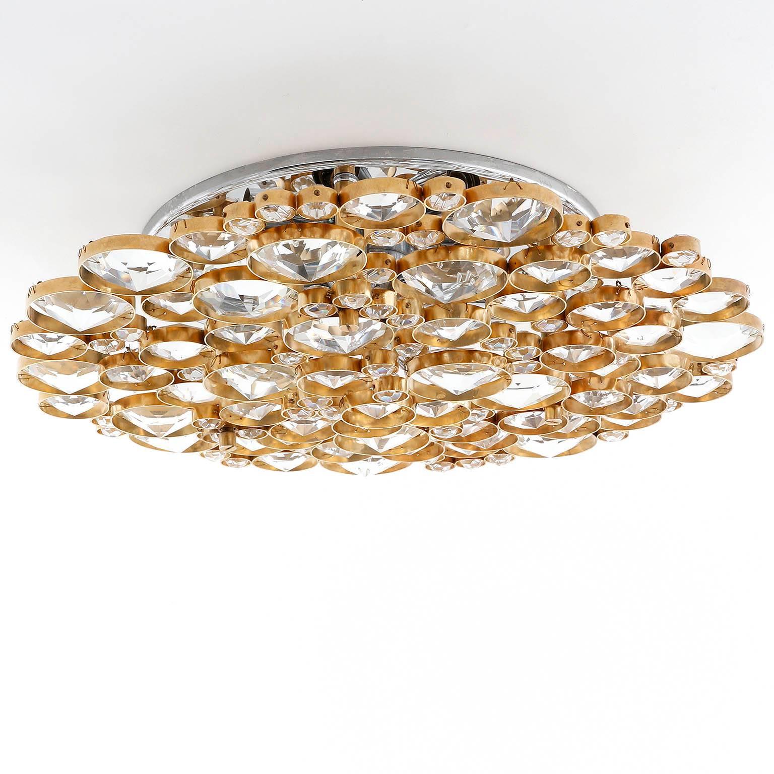 A unique and high quality flush mount light or wall light fixture by Bakalowits & Soehne, Austria, manufactured in Mid-Century, circa 1960.
The lamp is made of a brass and nickel frame decorated with hand cut crystal glasses. The crystals are in