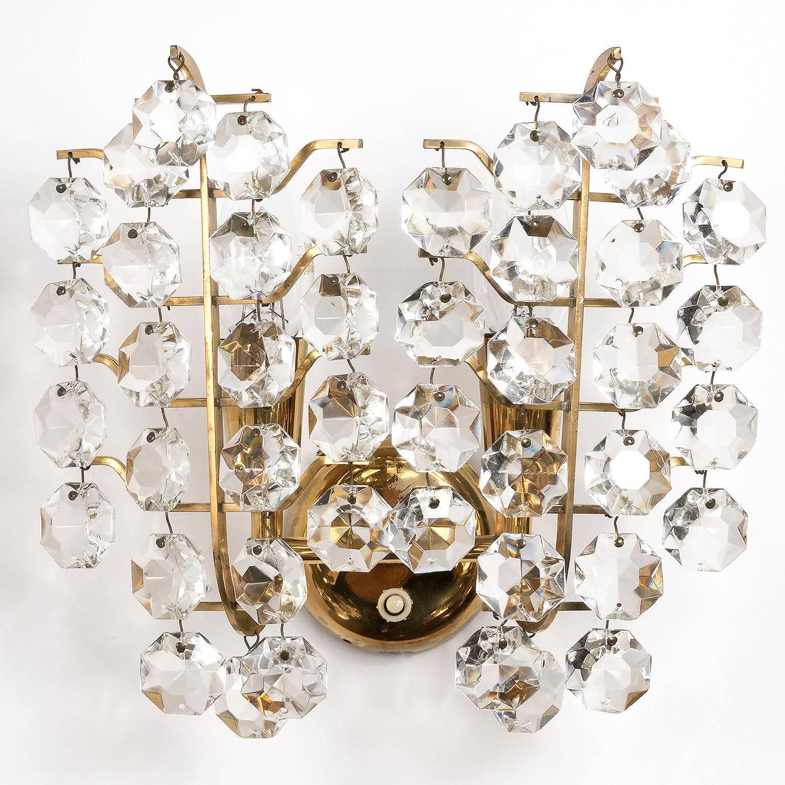 A pair of high quality and handmade wall lights by Bakalowits & Söhne Vienna, Austria, manufactured in midcentury, circa 1960 (late 1950s or early 1960s). 
A brass frame with lovely patina is decorated with diamond shaped crystal glass pieces. Very