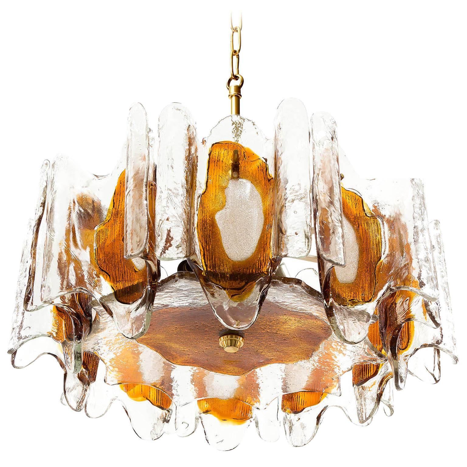 A beautiful pendant chandelier made of melted orange / amber tone Murano glass by Kalmar, manufactured in midcentury, circa 1970 (late 1960s or early 1970s).
The light fixture has five sockets for small screw base bulbs or LEDs.
The lights can be