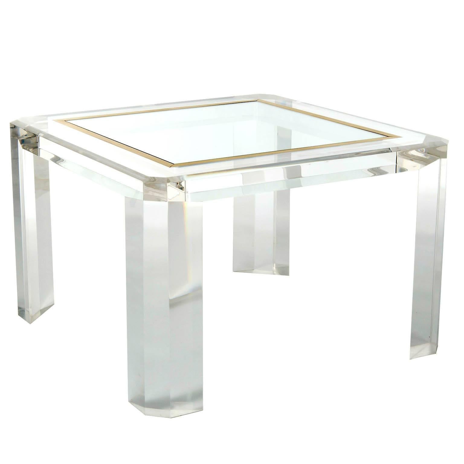 A pair of square hollywood regency cocktail or coffee tables made of Lucite, brass and glass manufactured in Mid-Century, circa 1970.
 