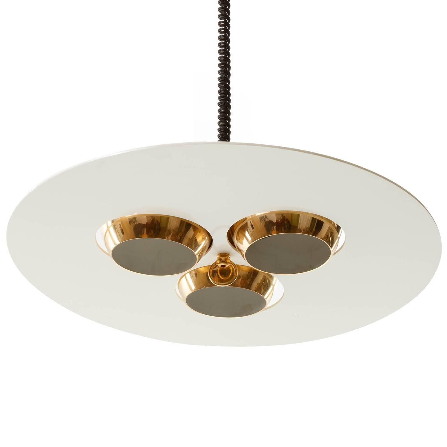 A high adjustable Italian pendant light manufactured in Midcentury in 1970s.
It is in the style of the Ettore Sottsass '19022 Lampros' chandelier for Stilnovo.
The three brass globe lamp shades can be rotated and positioned in different ways.