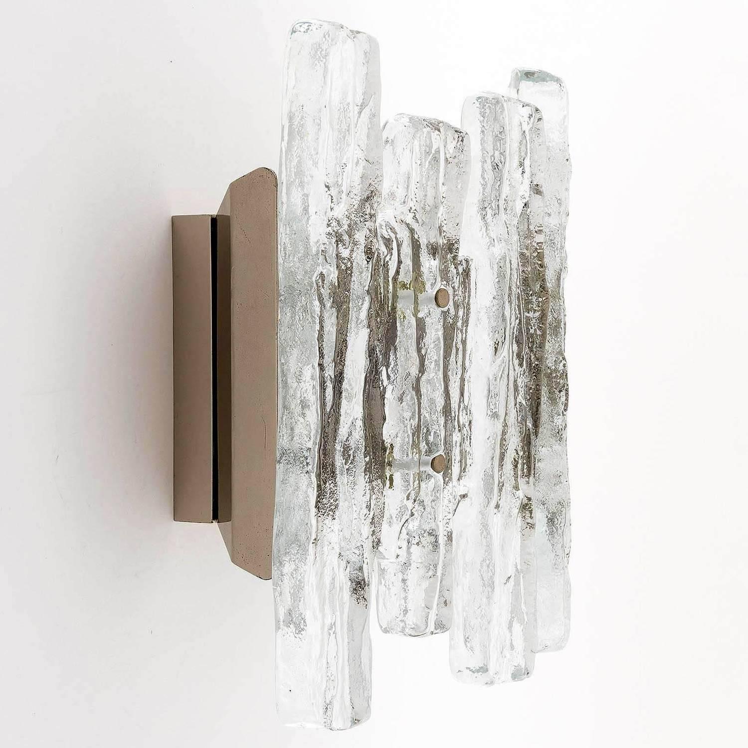 A beautiful pair of ice glass wall lights model 'PUCK' (no. 4518) by J.T. Kalmar, Austria, manufactured in midcentury, circa 1970 (late 1960s or early 1970s).
This is the rarer version of the icicle glass sconces from Kalmar with larger glasses and