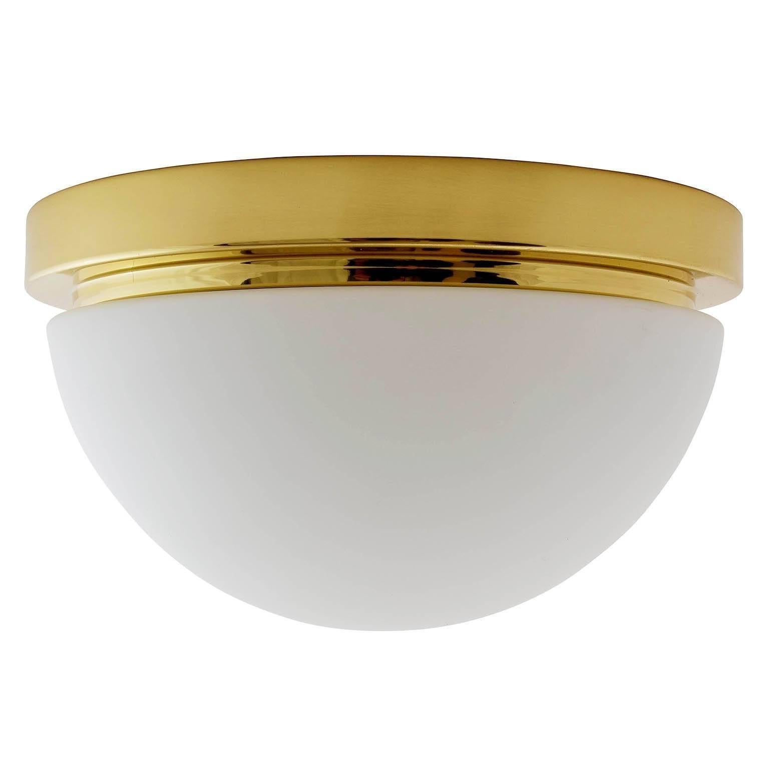 One of eight flush mount or wall lights by Glashütte Limburg, manufactured in midcentury, circa 1970.
They are made of a polished brass armature with a dome shaped opal glass lampshade. Labelled with Glashütte Limburg.
The price is per light. They