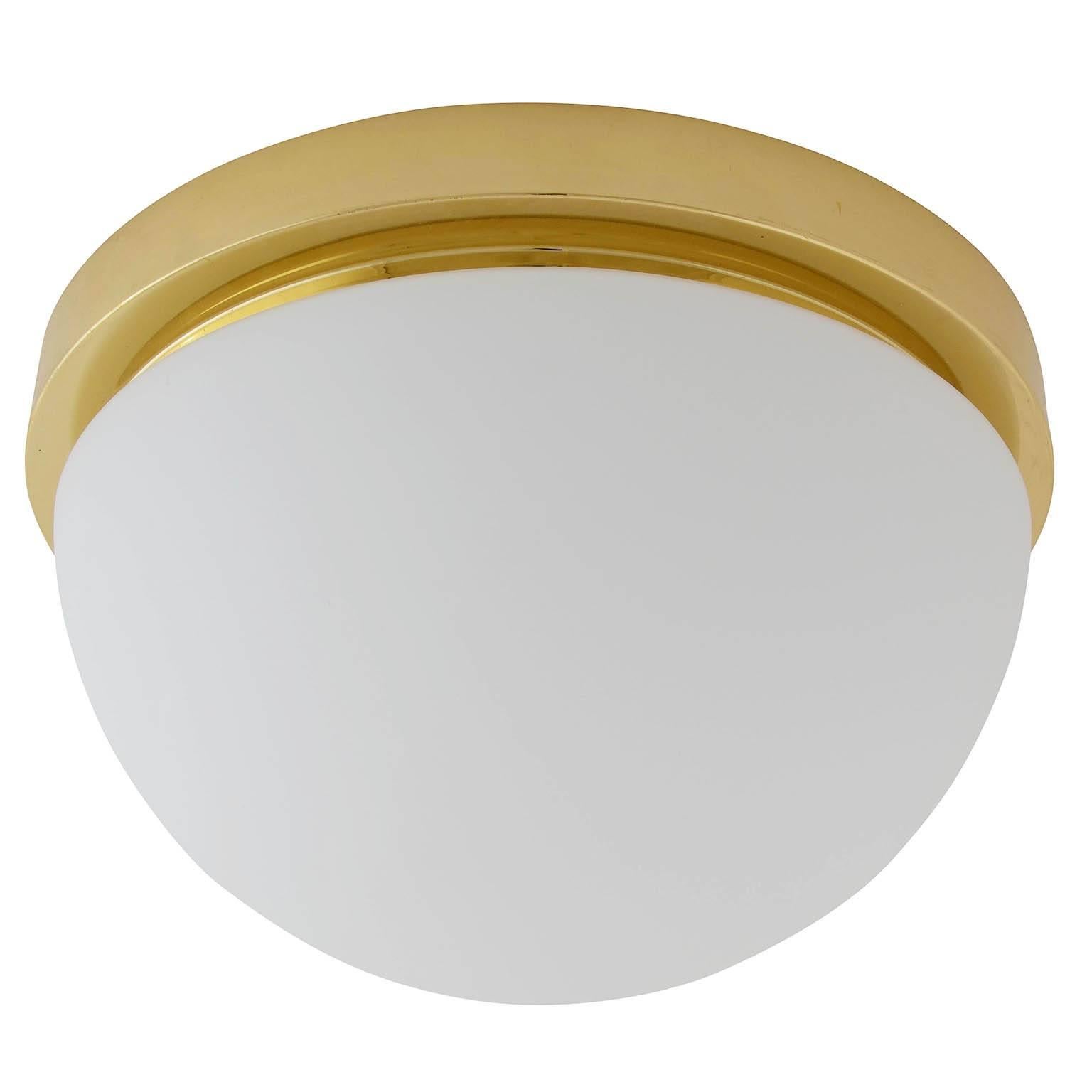 One of four flush mount lights or sconces by Glashütte Limburg, manufactured in midcentury, circa 1970.
They are made of a polished brass armature with a dome shaped opal glass lampshade. Labelled with Glashütte Limburg.
The price is per light. They