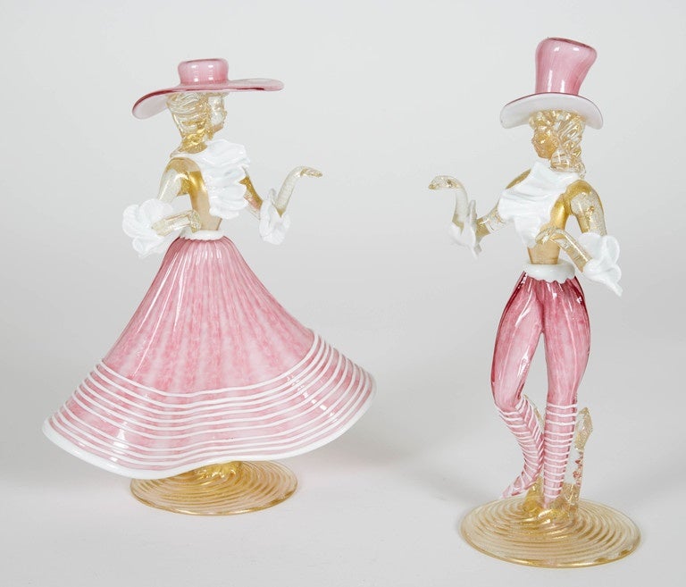 Pair of pink, gold and white dancing Murano figurines. These 1950s figurines are a conversational piece for any room or salon.