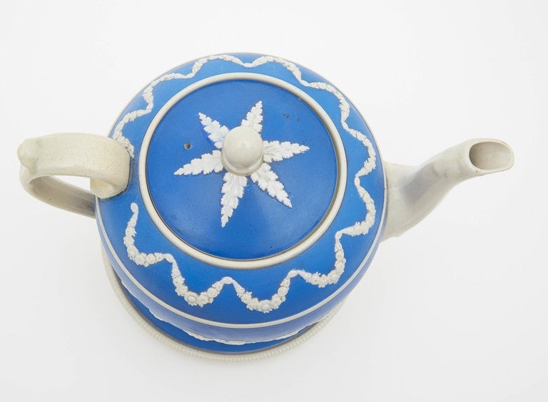 Antique blue and white spode tea pot and stand. Elegant details of dancing ladies create a happy atmosphere for any tea party. This striking blue tea pot is from the 1890s.