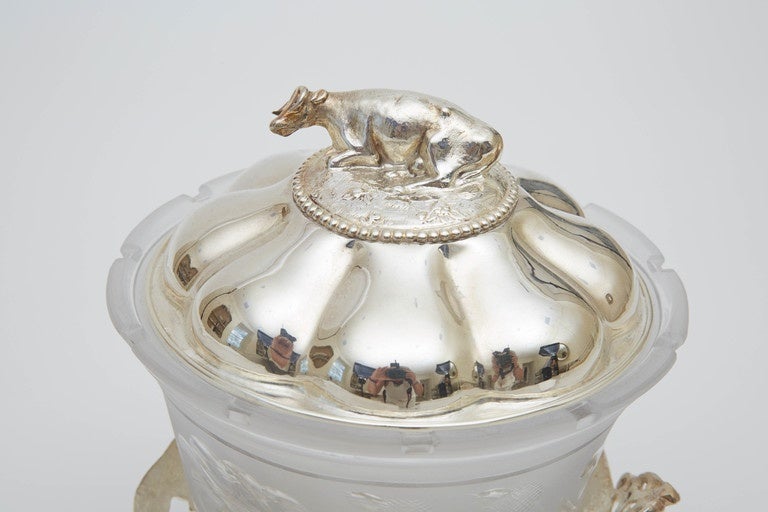 Antique English butter or cheese dish made of silver and frosted glass. Beautiful details include a cow engraving on the lid and an ornate base.