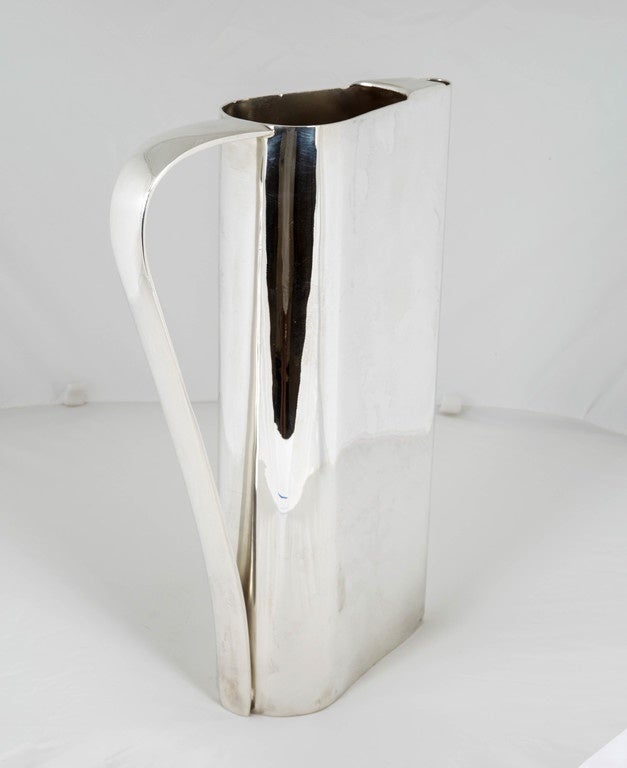 Silver vintage Italian water pitcher from the 1950s. This sleek design creates a modern look.