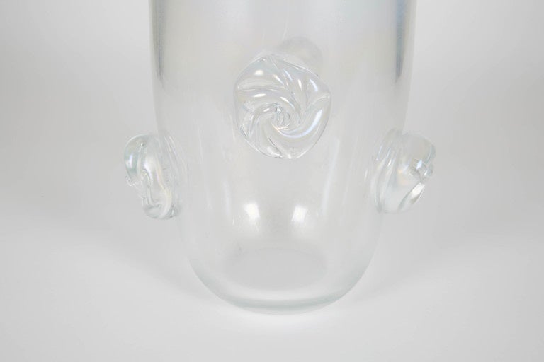 Mid-20th century tall Murano vase. Rosette detailing around surface create an elegant yet subtle detail to the item. It is a beautiful item for a table centerpiece or shelf display.