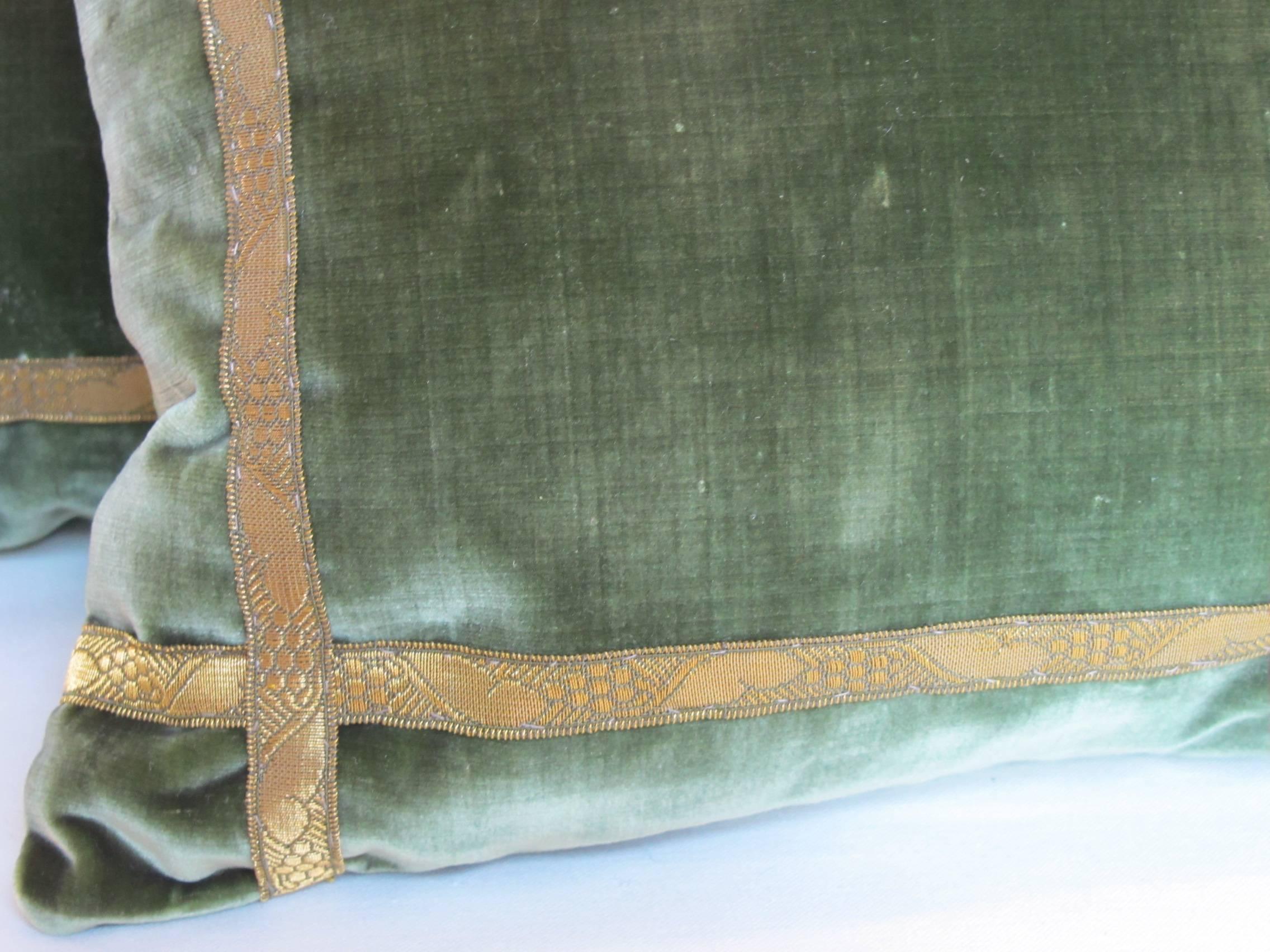 Newly made pillows from an early 20th century silk velvet embellished with antique metalic trim, backed in coordinating green silk