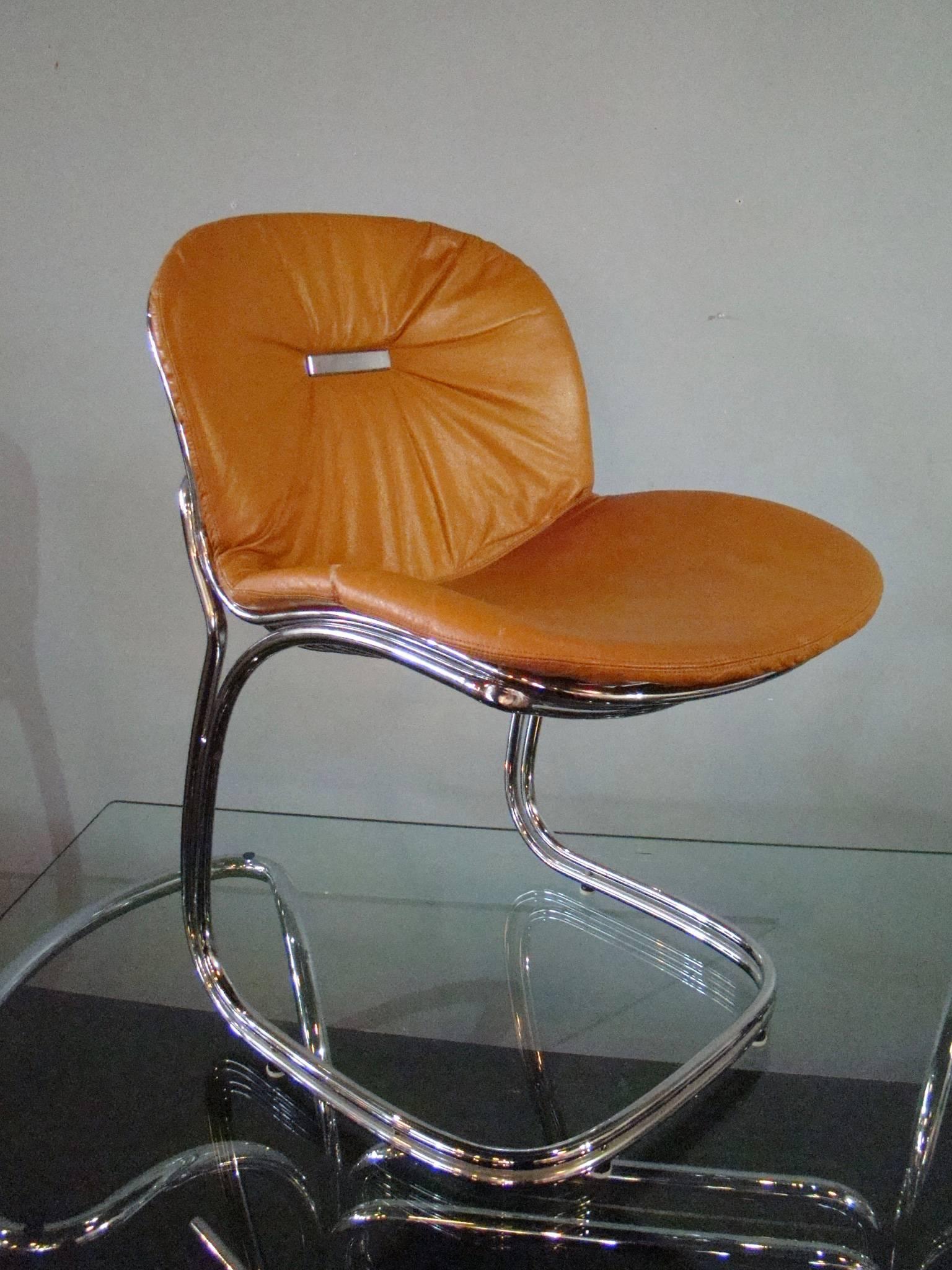 Six chrome and leather side chairs by Italian design legend Gastone Rinaldi. Original caramel leather seat upholstery is in very good to excellent condition. Chairs are graceful and comfortable. Chairs measure 24" D x 21" W x 33" H