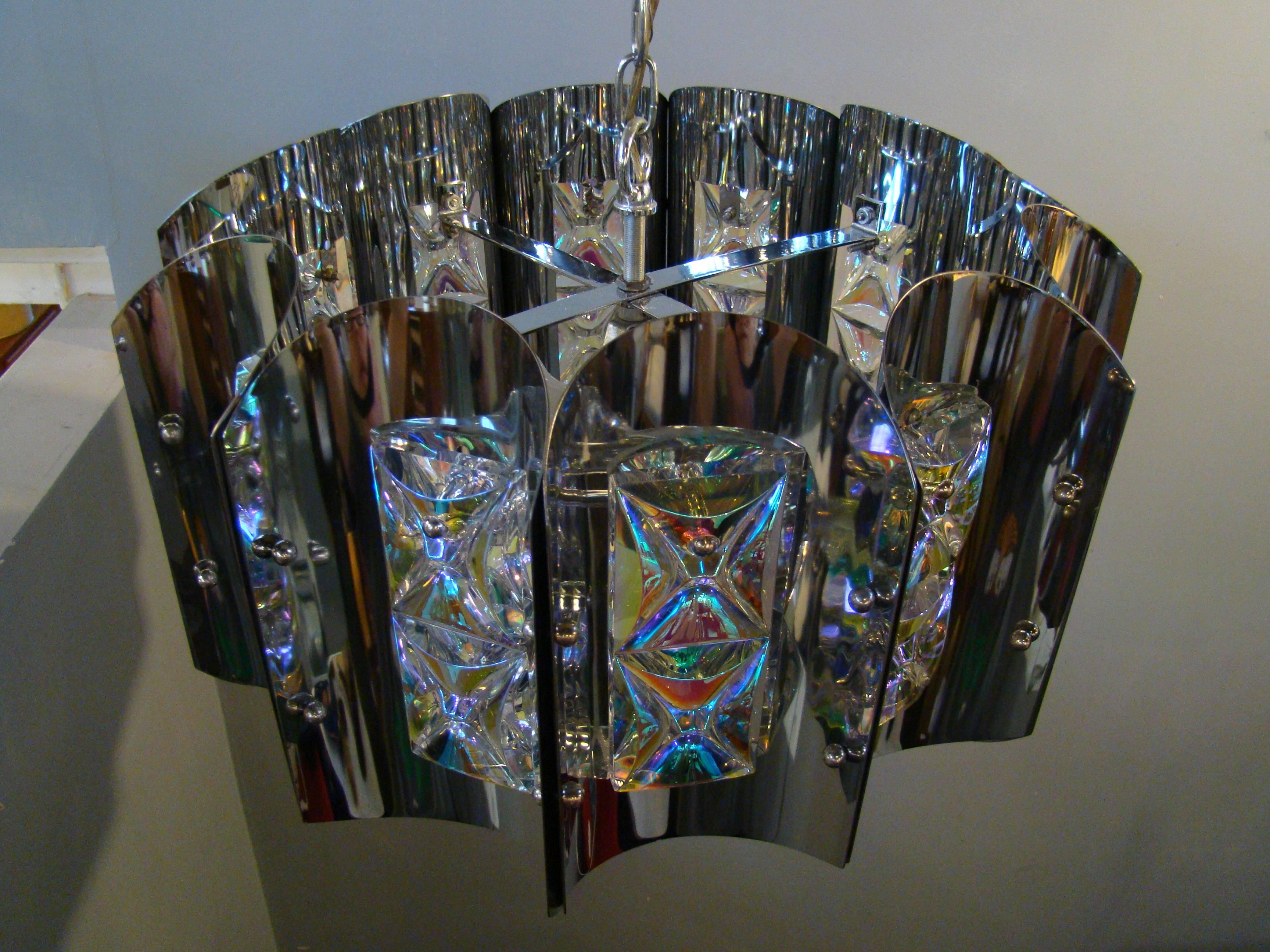 Crystal adorns each chrome panel of this beautiful modernist lamp. When lit, it is the focal point of any room. Utilizes three bulbs.