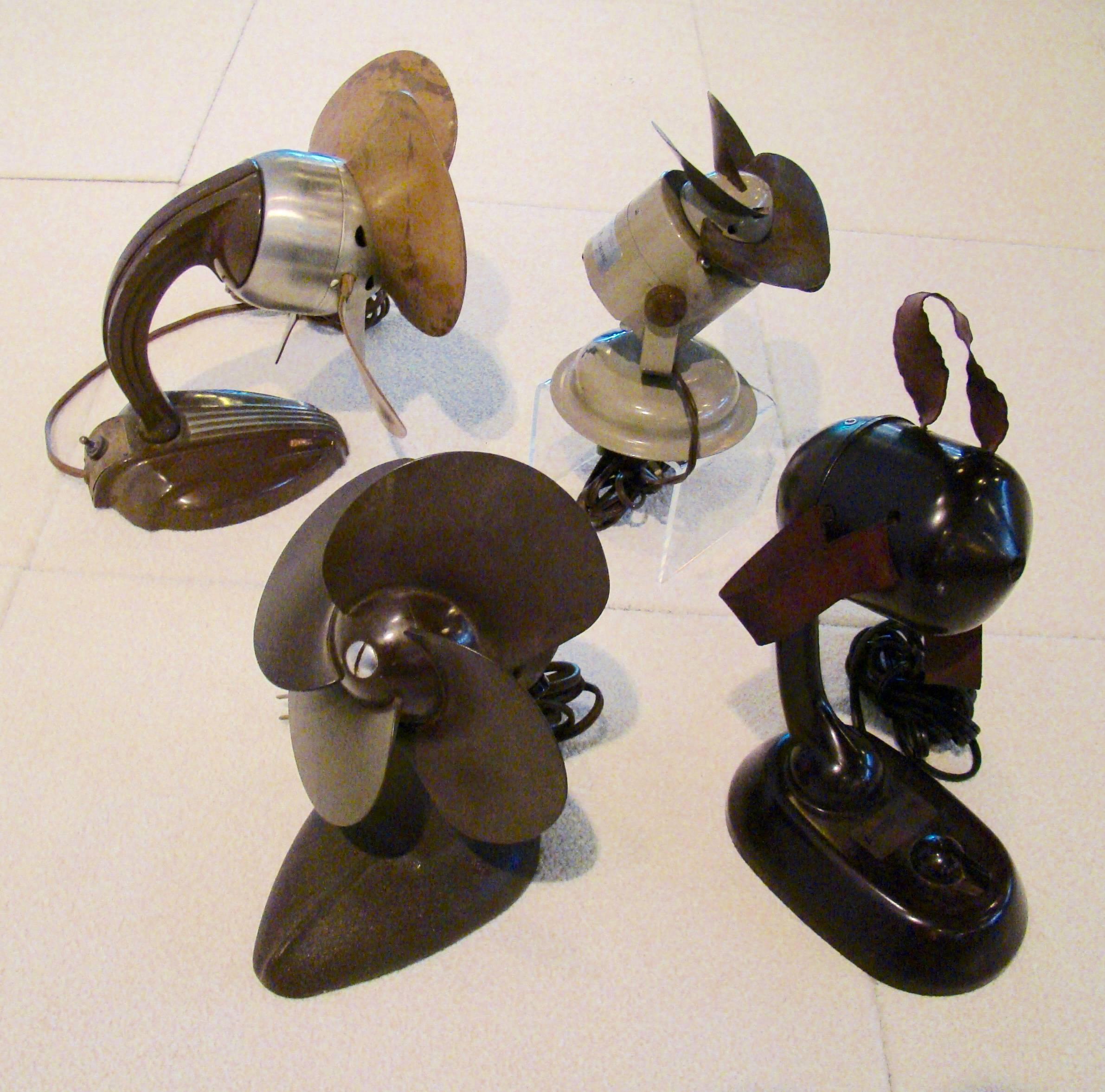 Instant collection of four outstanding and unique tabletop fans from the Art Deco era. From left to right are the descriptions and dimensions:
Airflow fan with bakelite base and upholstery blades 10.5