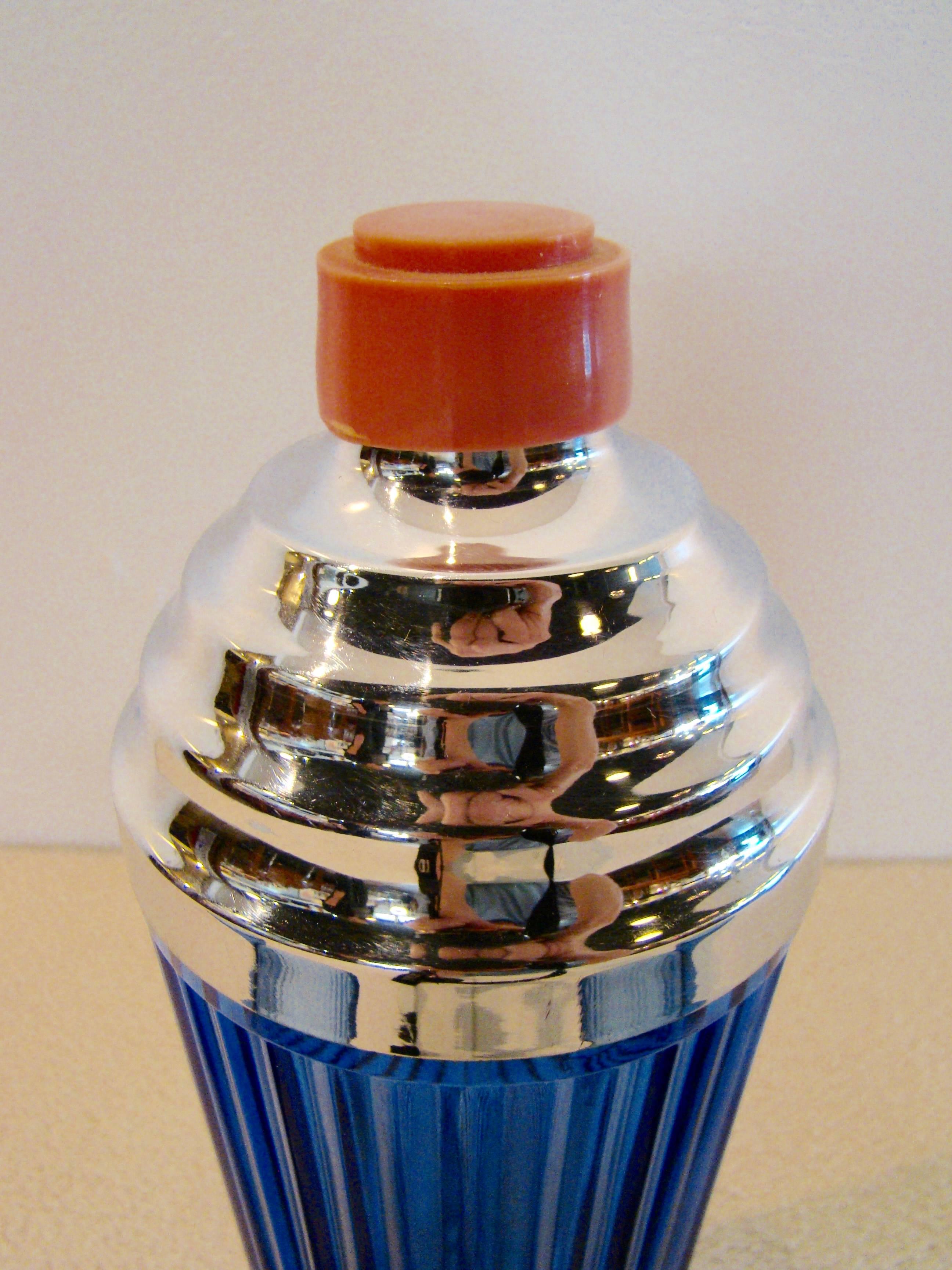 Art deco cobalt cocktail shaker with chrome stepped top and bakelite spout cap. Matching glasses are also ribbed with chrome stepped bases. The epitome and glamour of the deco era. Drink in style!
Measures: Shaker is 11