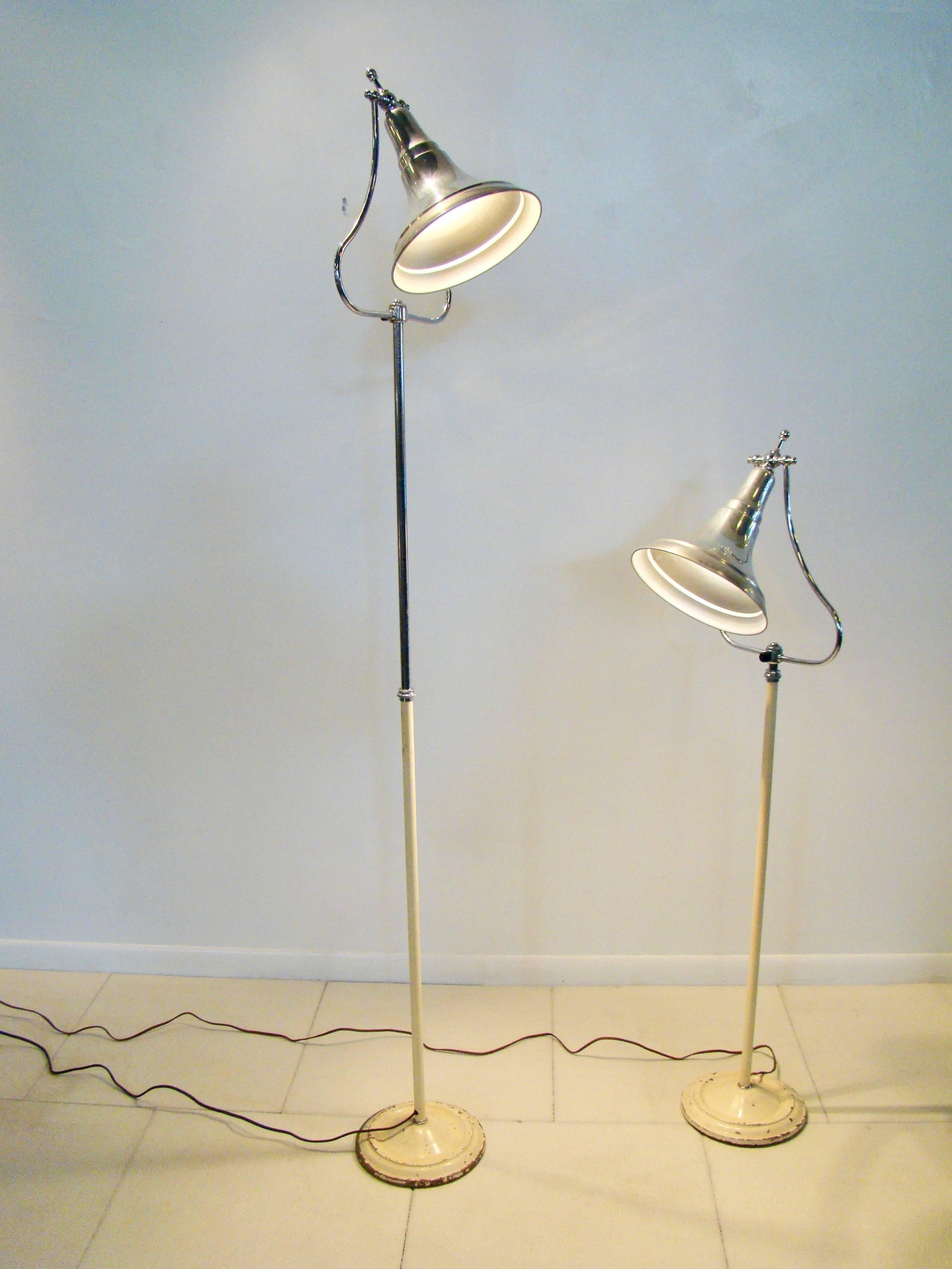 Machine Age Industrial medical bell shaped floor lamps. The bell is comprised of aluminium and chrome and tilts and adjusts up and down. The base is chrome and painted metal.